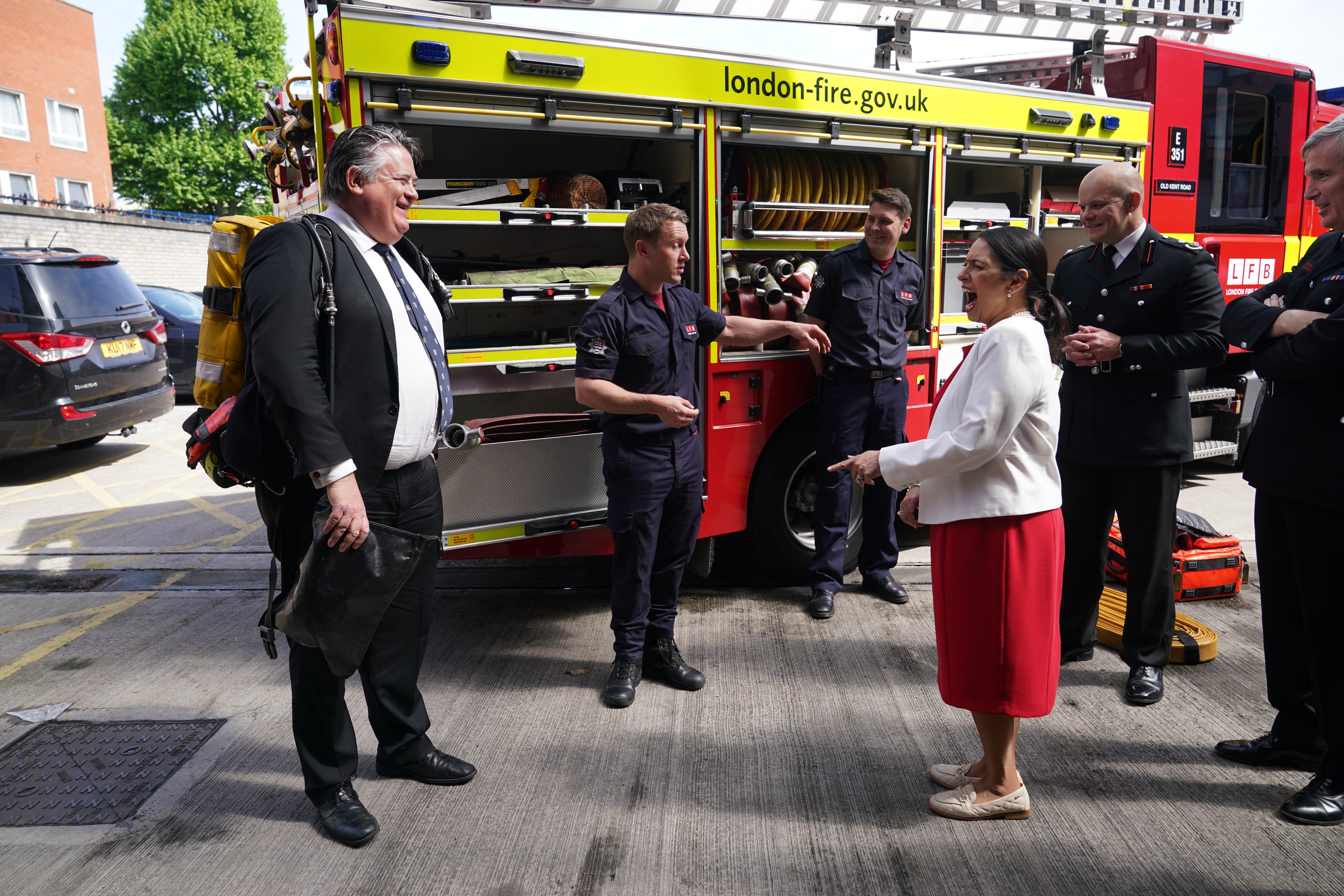 Housing minister Lord Greenhalgh, wearing a set of breathing apparatus, with Home Secretary Priti Patel during a visit to Old Kent Road Fire Station (Yui Mok/PA)