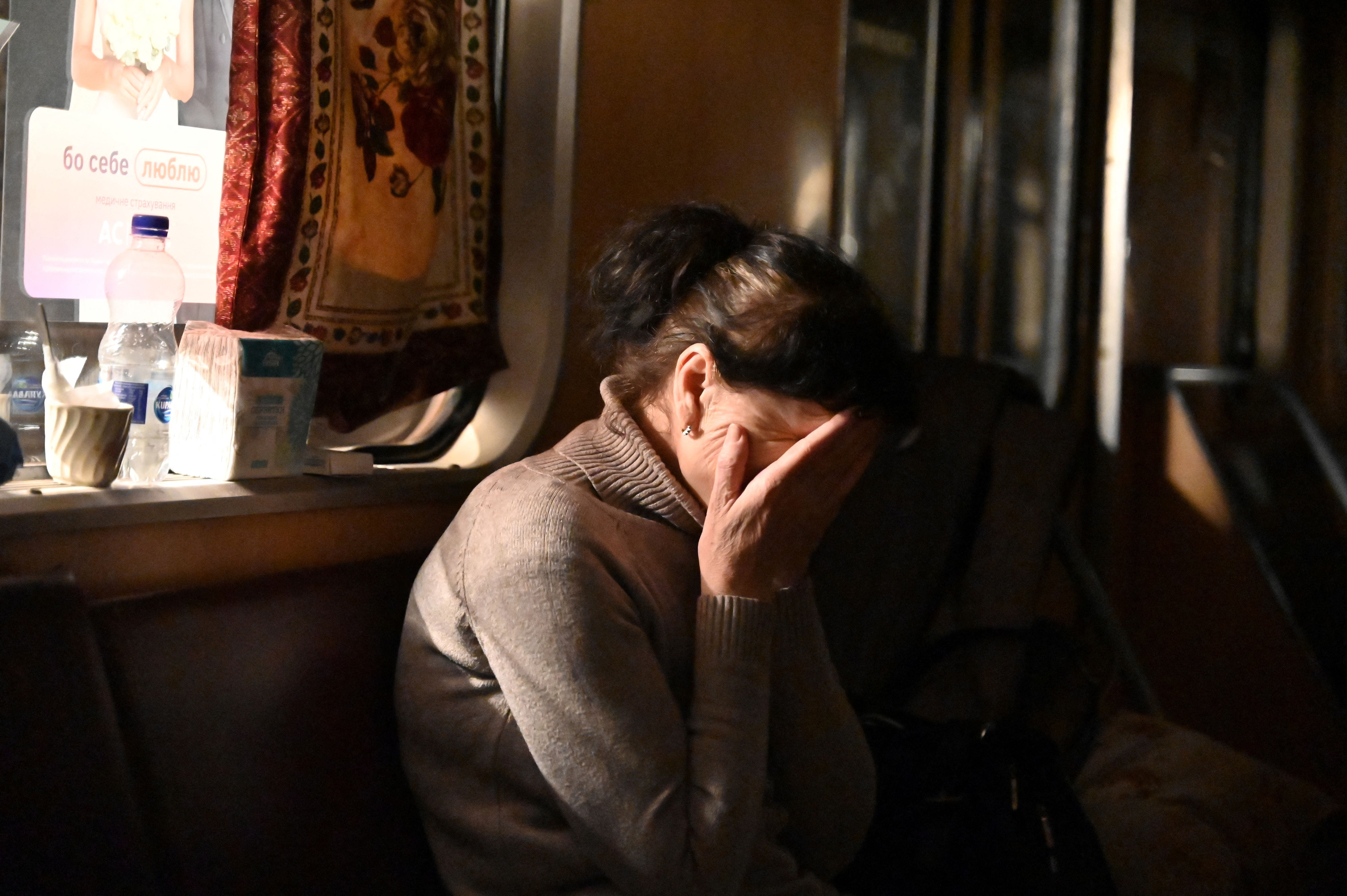 A woman gestures as she shelters with others in a subway station on the northern outskirts of second largest Ukrainian city of Kharkiv