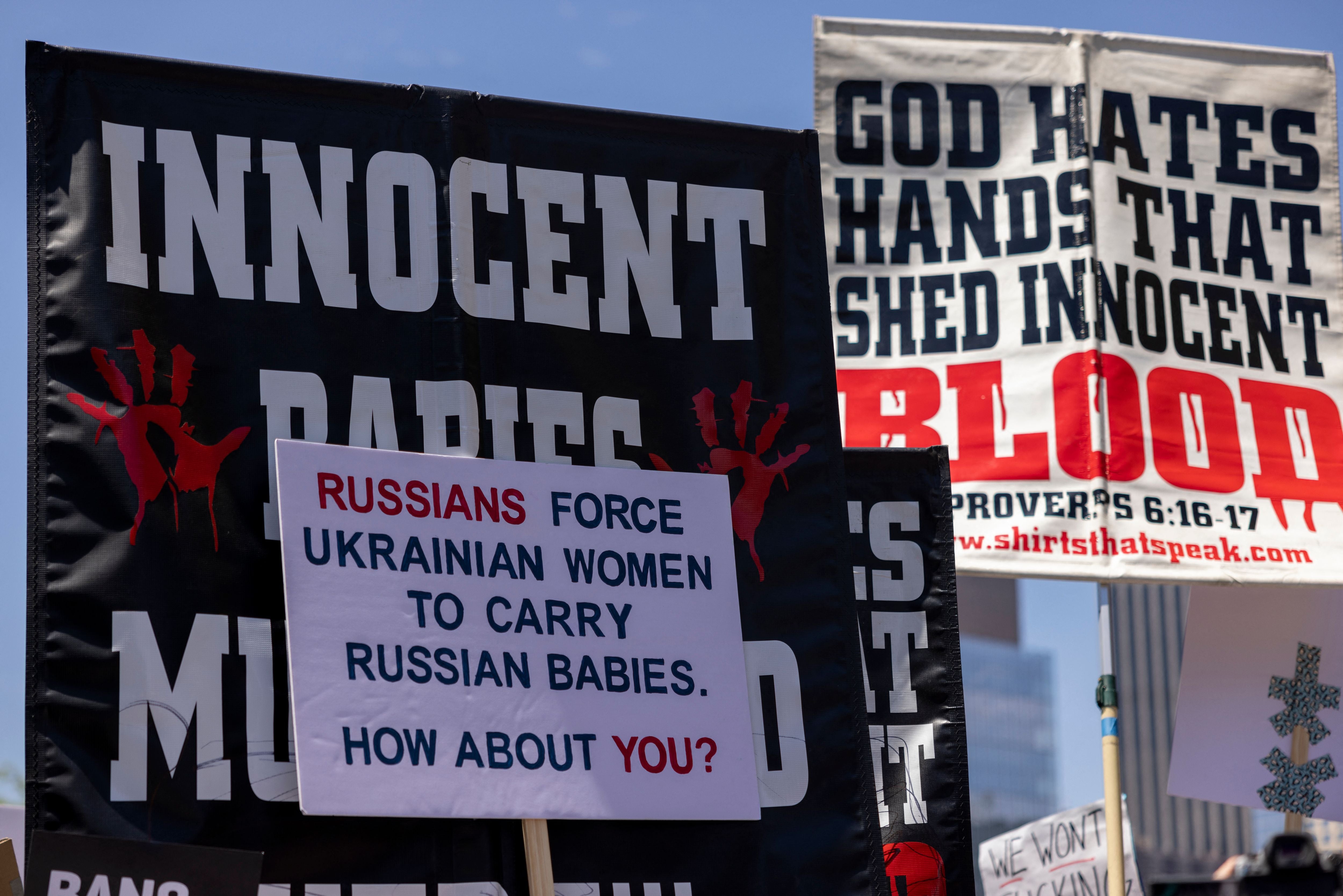 Signage pertaining to alleged impregnation through rape by Russia forces in Ukraine without abortion as a choice rally is held in Los Angeles, California