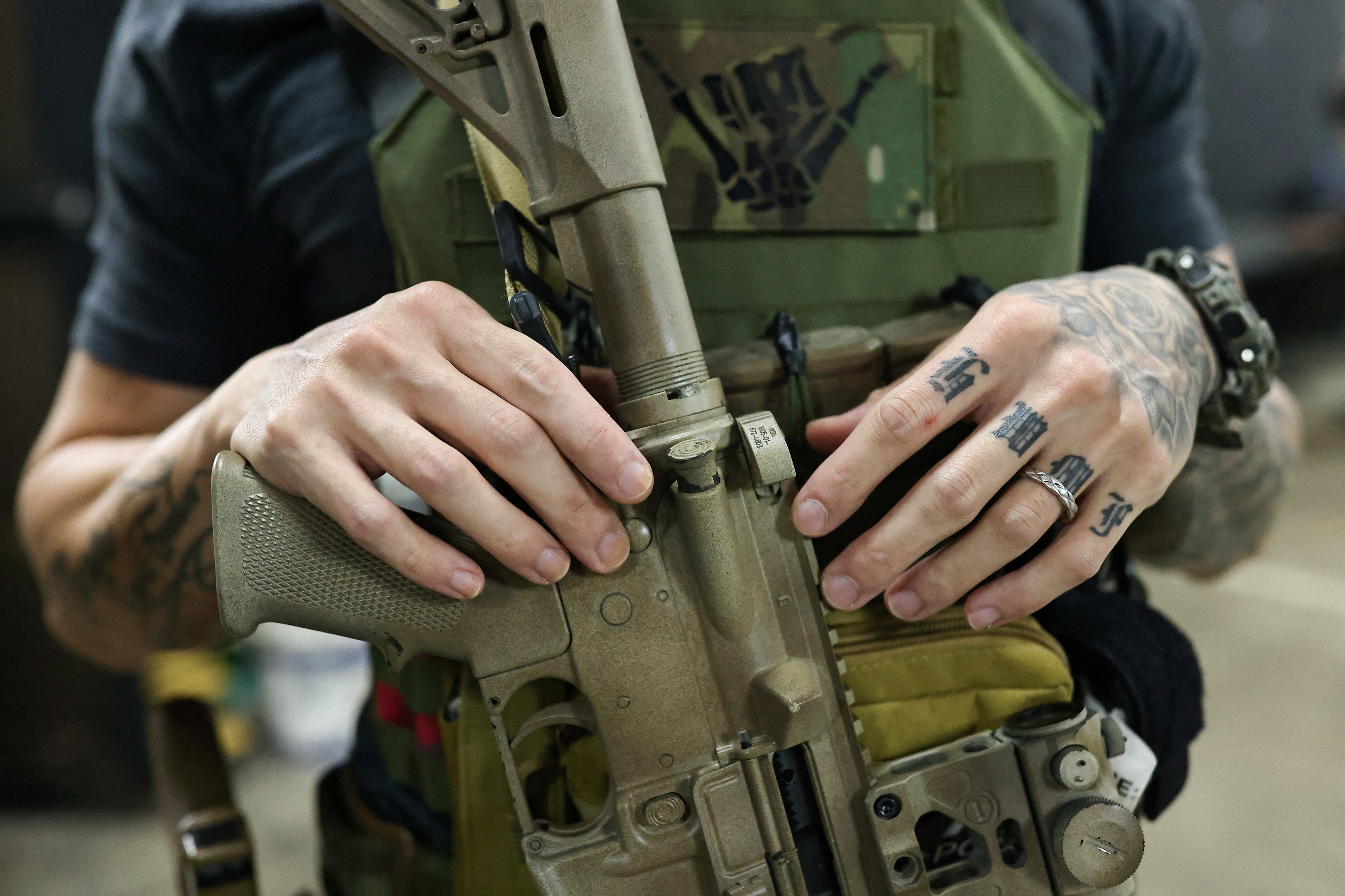 Personal trainer Chris Chen poses with an airsoft gun