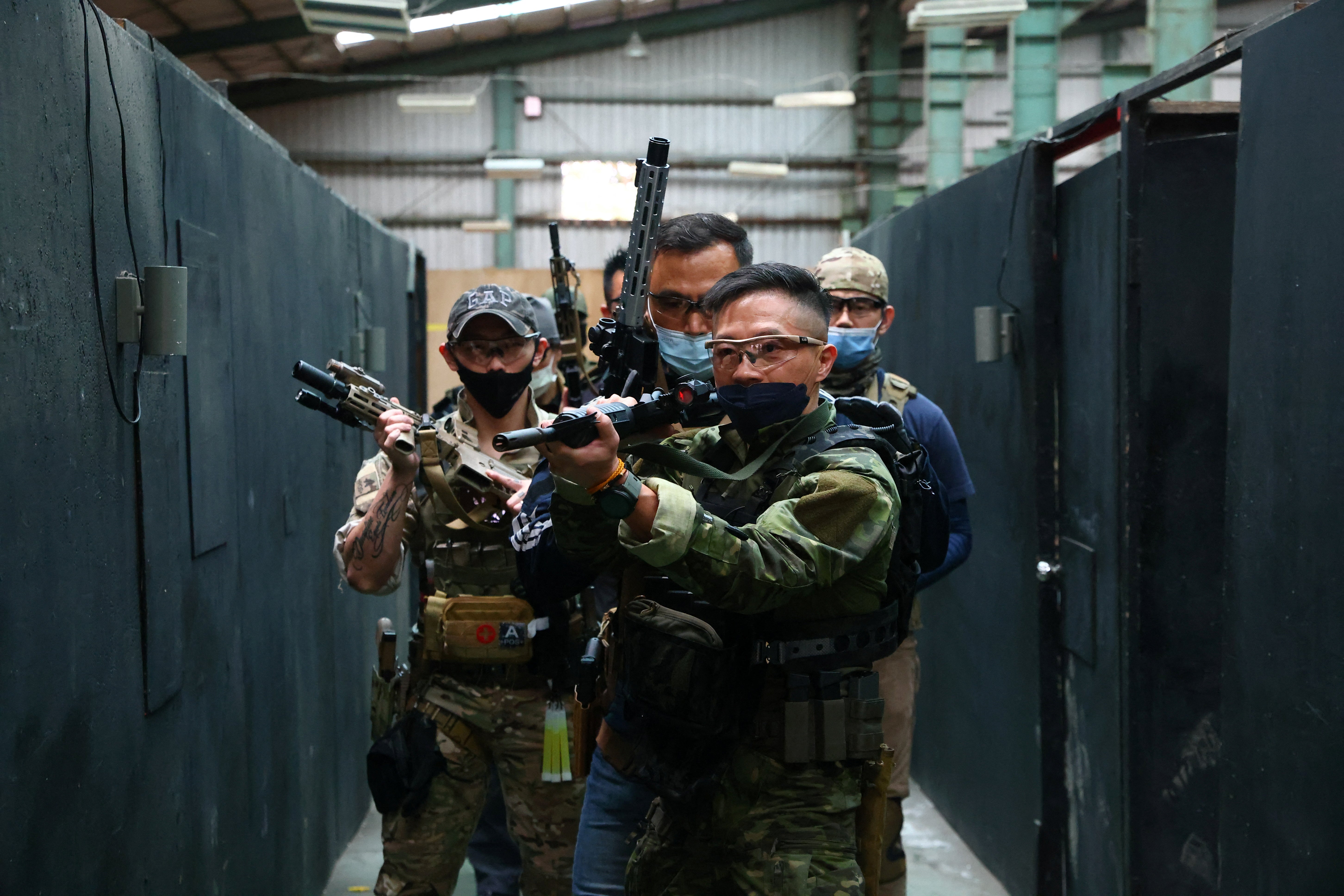 Trainees prepare to enter a building in training