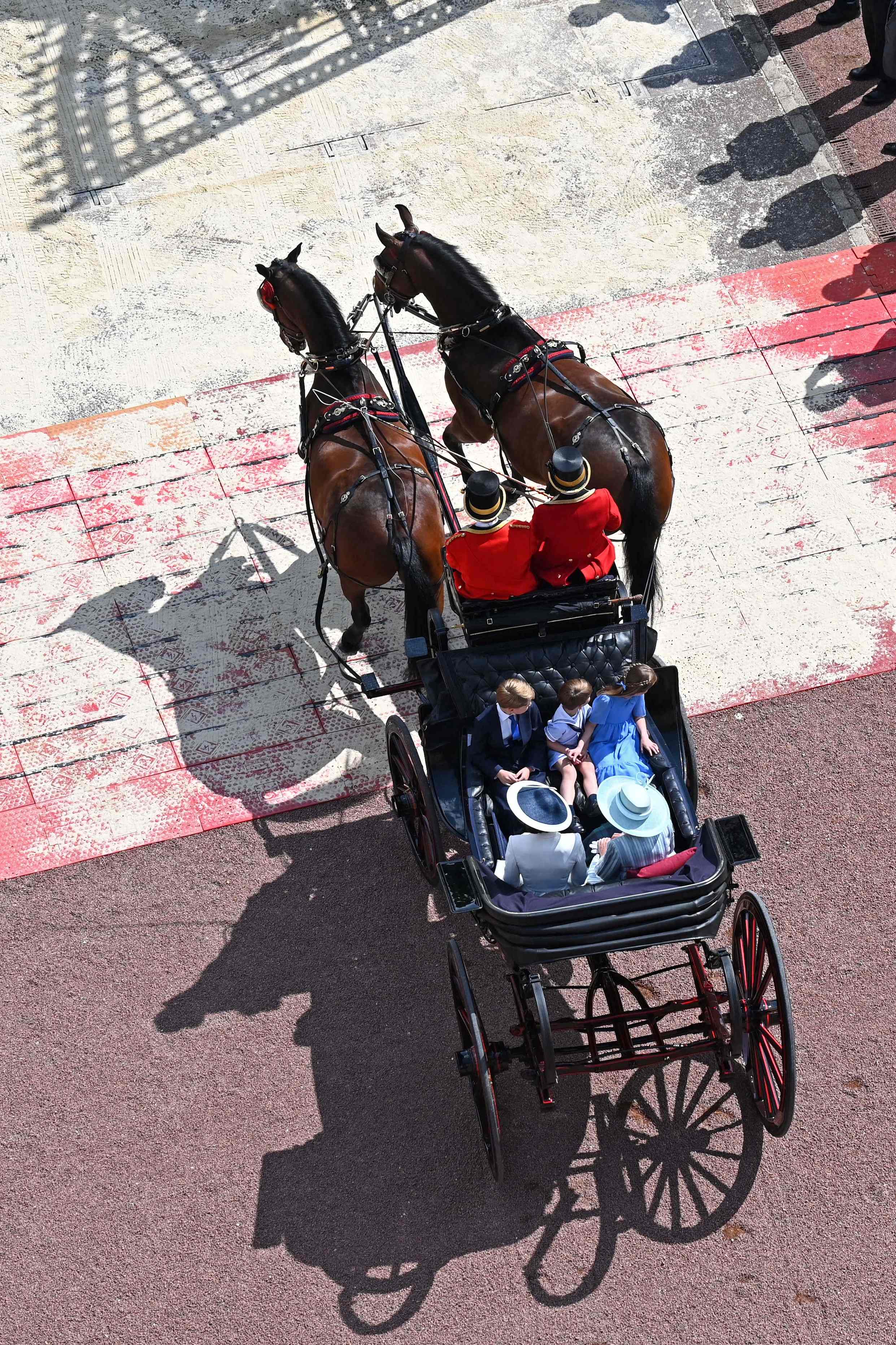 The Duchess of Cambridge, her children and Camilla, Duchess of Cornwall travel in a horse-drawn carriage during the Queen’s Birthday Parade, the Trooping the Colour