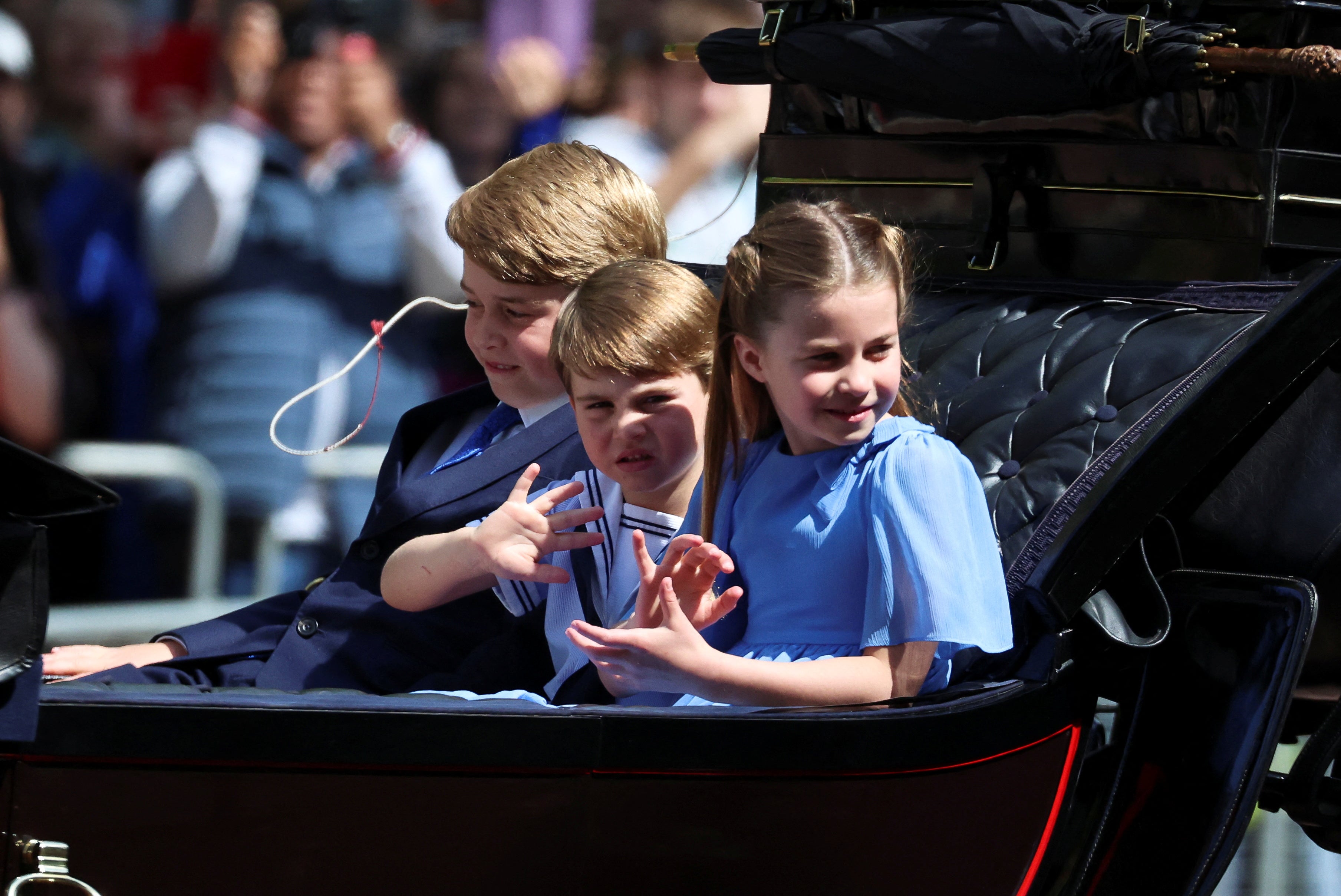 The royal children rode in a carriage along the Mall as a part of their first appearance at the Trooping the Colours parade.