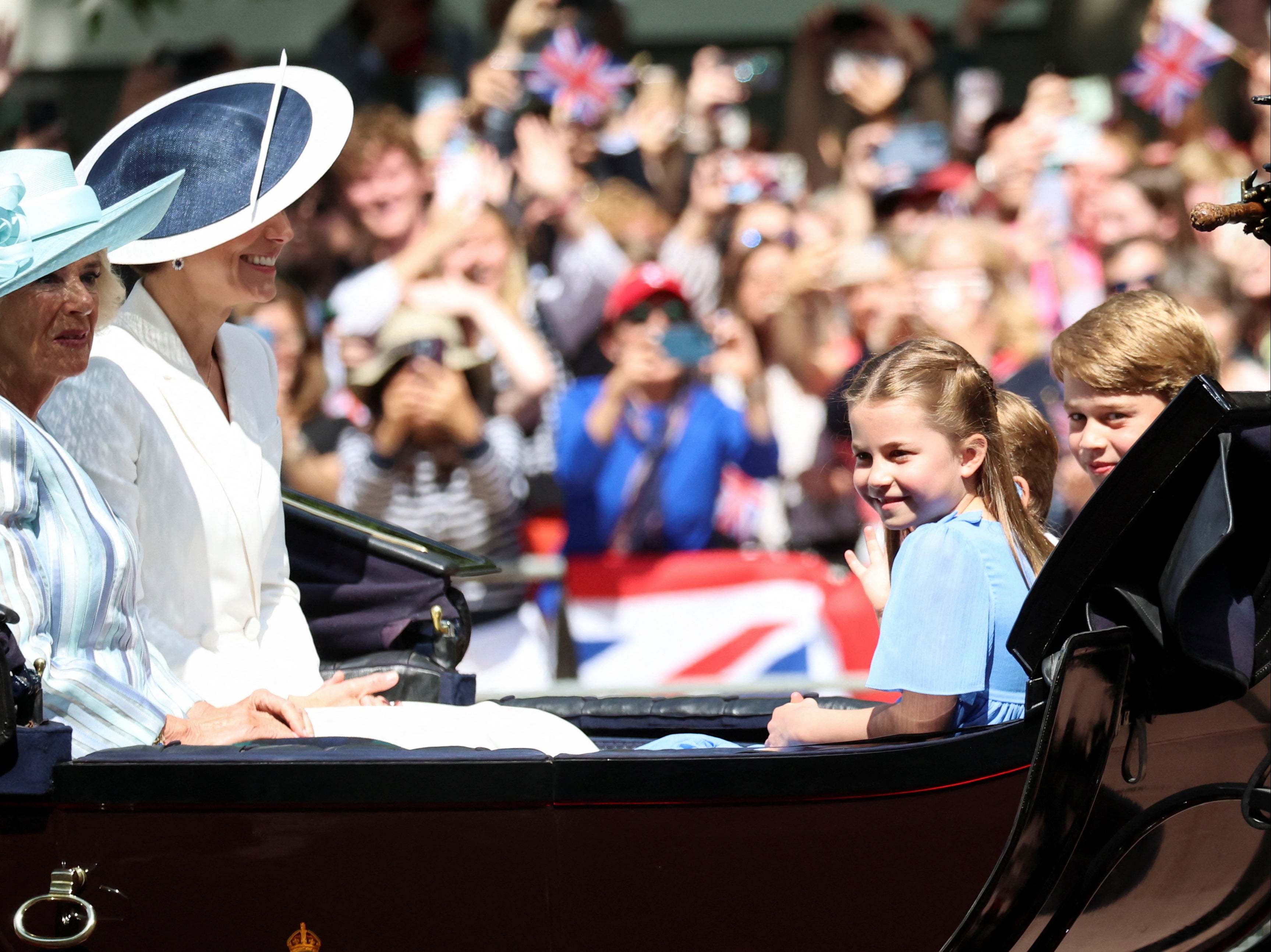 Princess Charlotte, Prince George and Prince Louis ride in a carriage during the Trooping the Colour parade