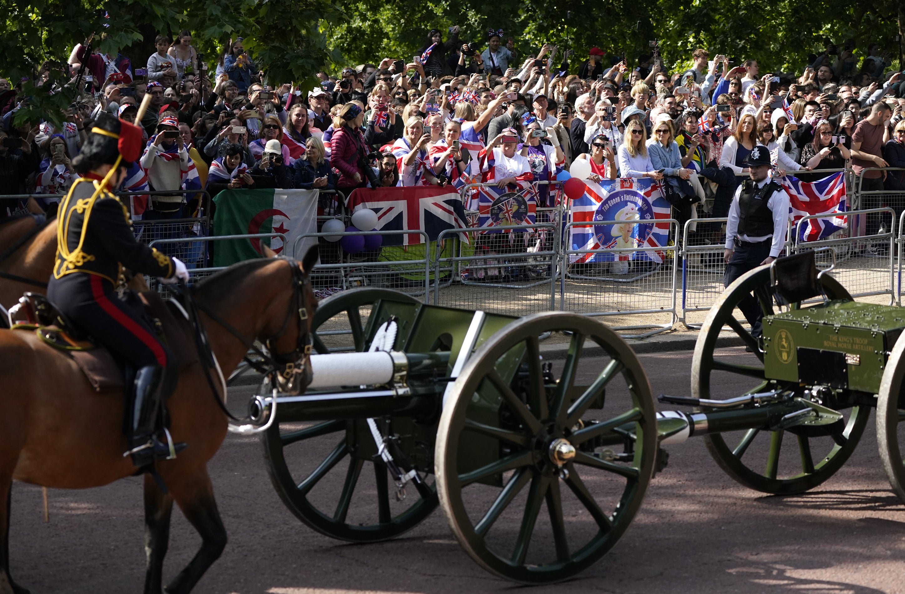 Royal fans watch as the Royal Procession heads to the Trooping the Colour ceremony at Horse Guards Parade, central London. (PA/Andrew Matthews)