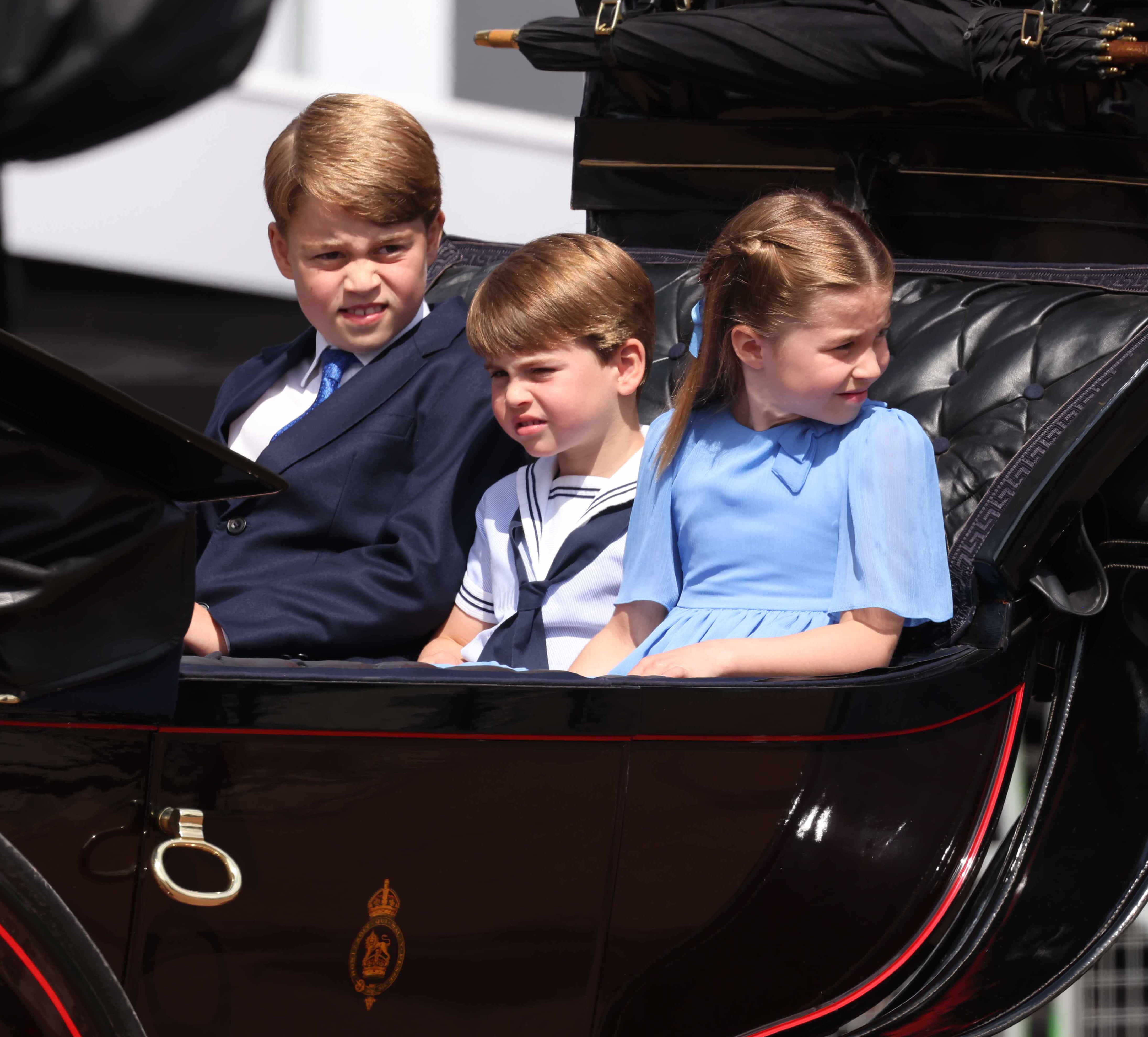 Prince George, Prince Louis and Princess Charlotte ride in a carriage as the Royal Procession leaves Buckingham Palace for the Trooping the Colour ceremony (Ian Vogler/Daily Mirror/PA)