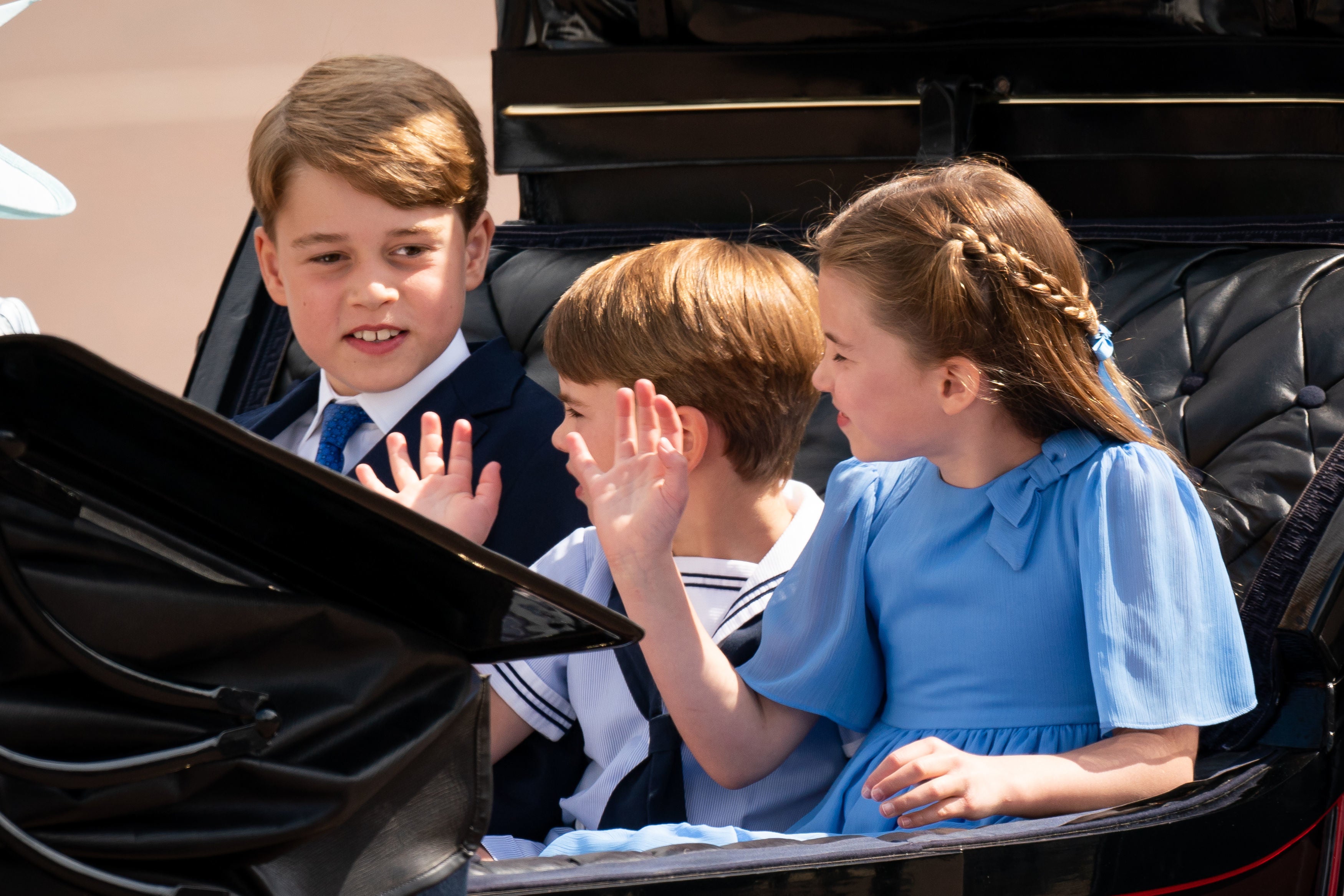 The children waved on at the large crowds gathered on the Mall outside Buckingham Palace