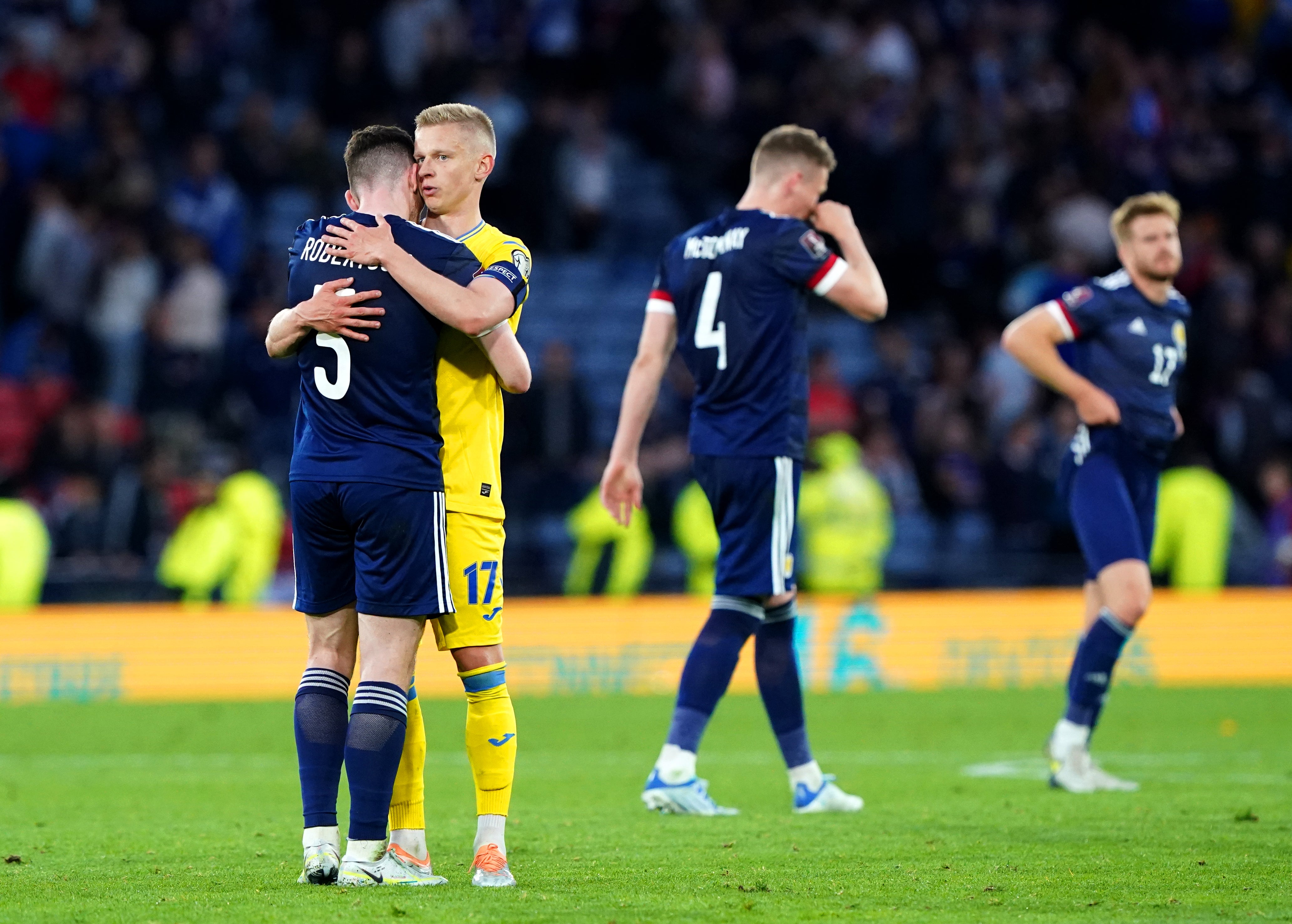 Robertson hugs Ukraine’s Oleksandr Zinchenko at the end of the game (Andrew Milligan/PA)
