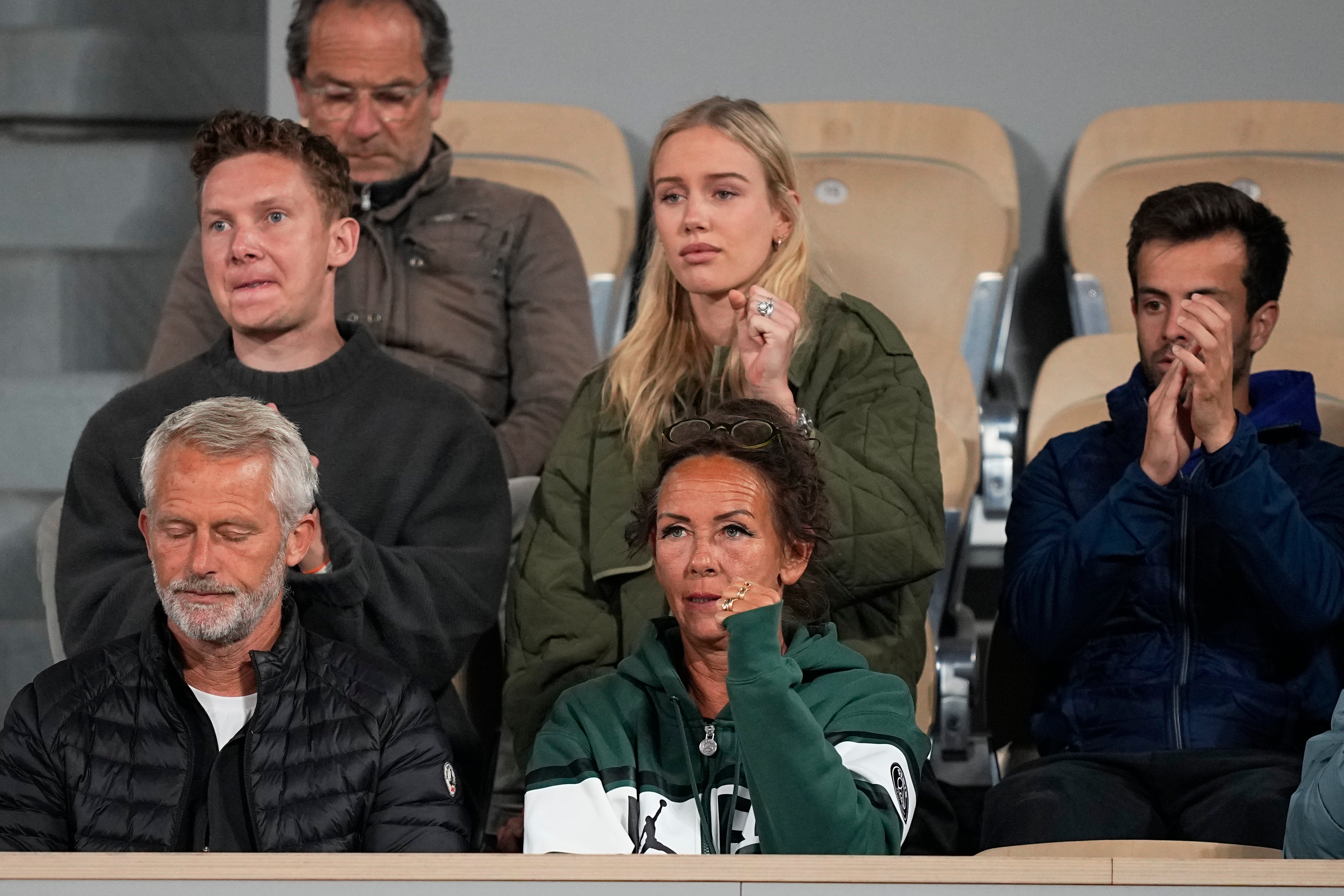 Rune’s mother Aneke, centre, watches the match (Michel Euler/AP)