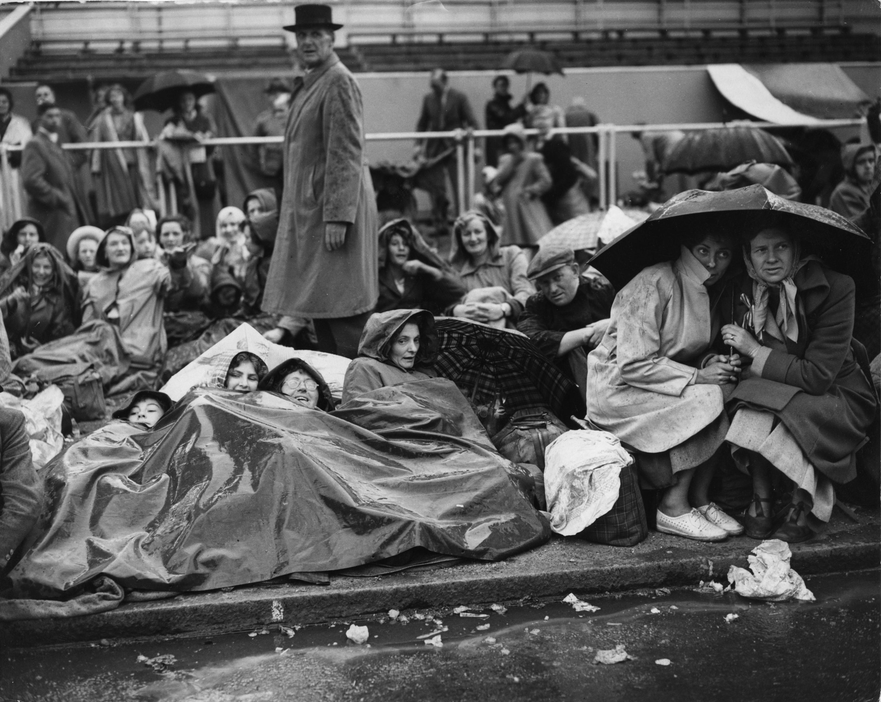 Crowds huddle on The Mall in rain ahead of the Queen’s coronation in 1953