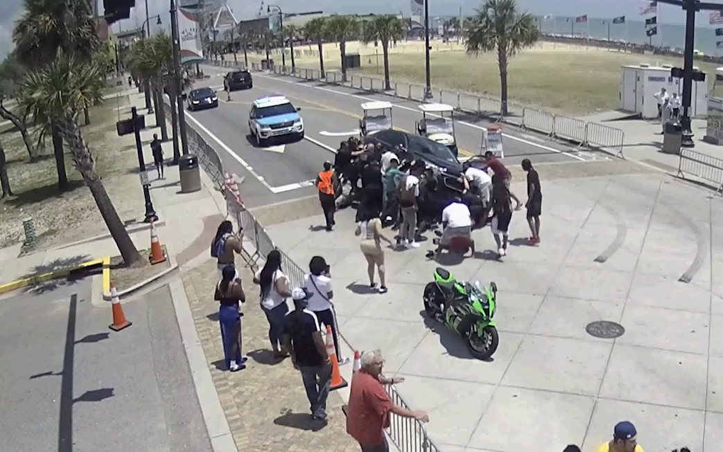 Officers and bystanders in Myrtle Beach who saw a motorcyclist get pinned under a car rush to rescue the man by working together to lift the vehicle off his body.