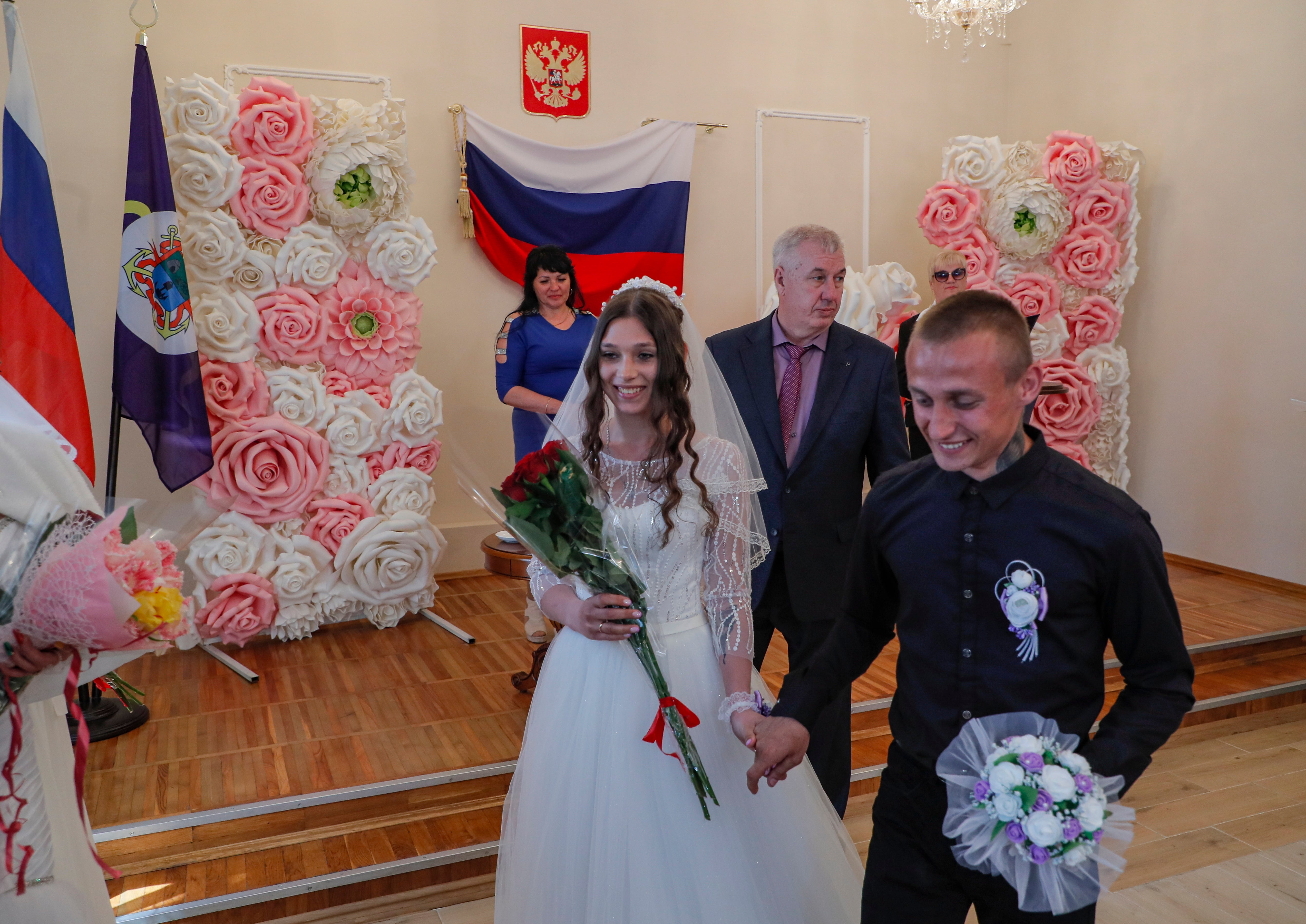 A picture taken during a visit to Mariupol organised by the Russian military shows the acting mayor of Berdyansk, Alexander Saulenko (centre) attending the register of marriages in the city’s wedding palace