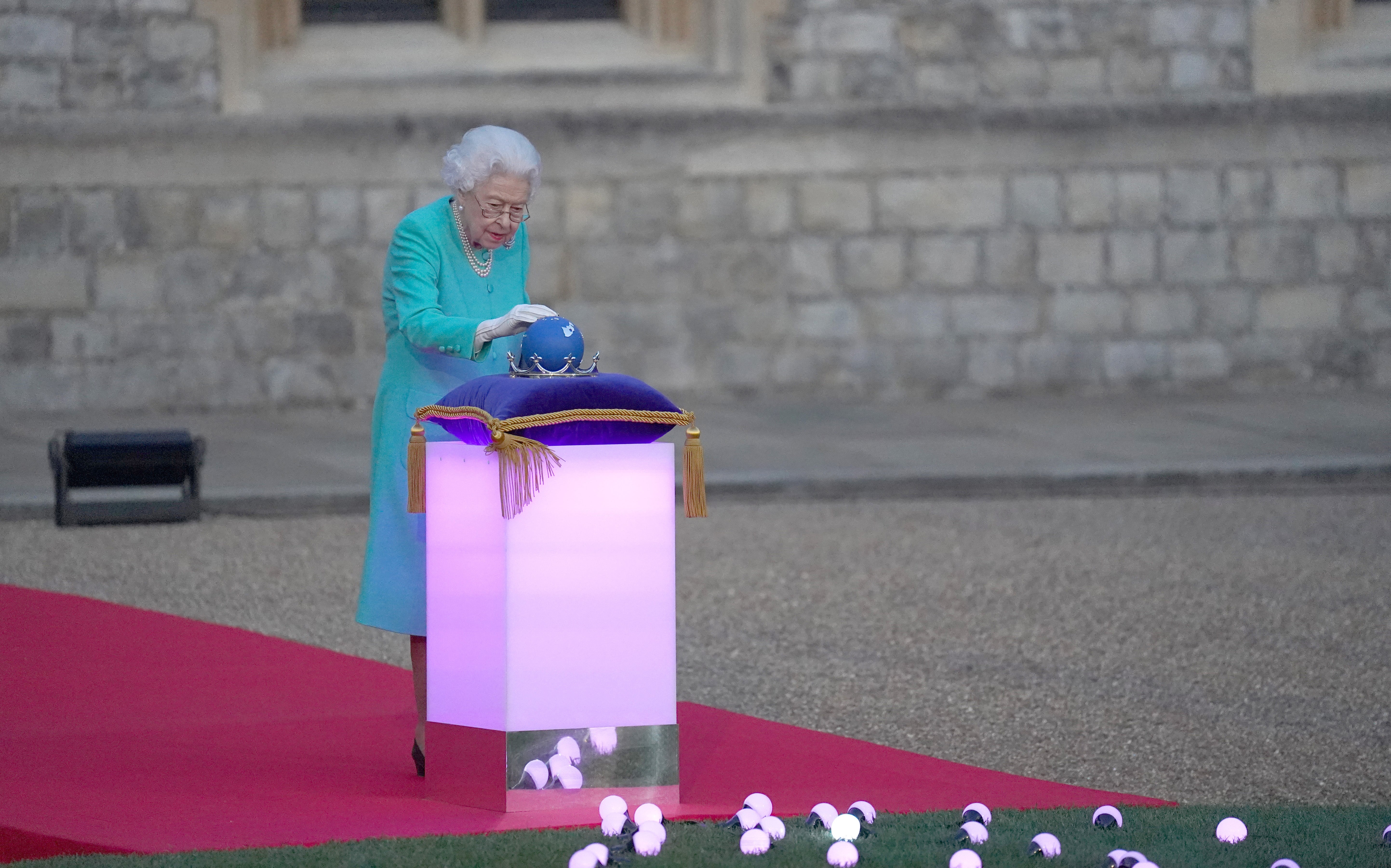 Queen Elizabeth II symbolically leads the lighting of the principal Jubilee beacon at Windsor Castle, as part of a chain of more than 3,500 flaming tributes to her 70-year-reign (Steve Parsons/PA).