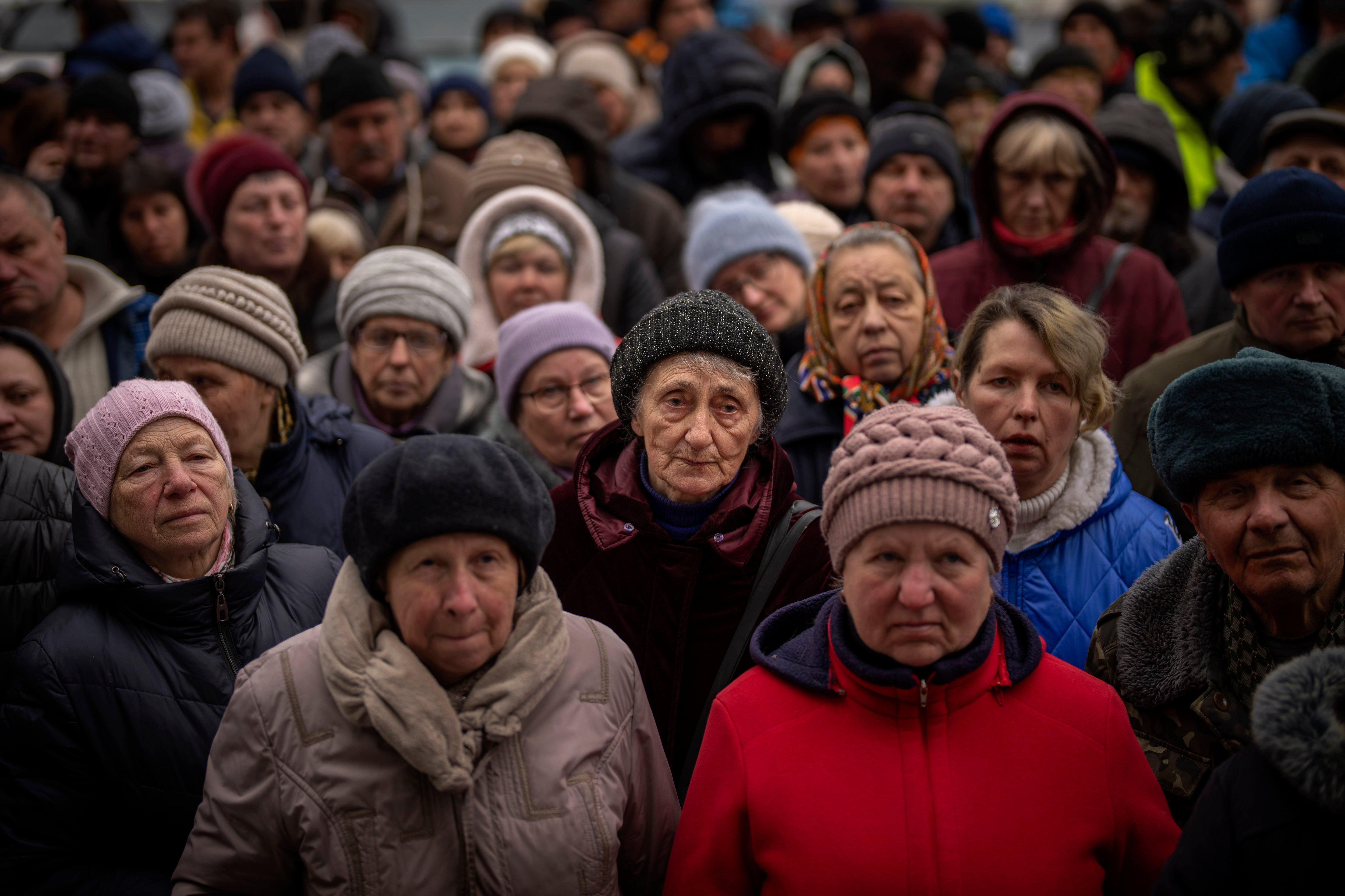 Ukrainians wait for a food distribution organized by the Red Cross in Bucha, on the outskirts of Kyiv