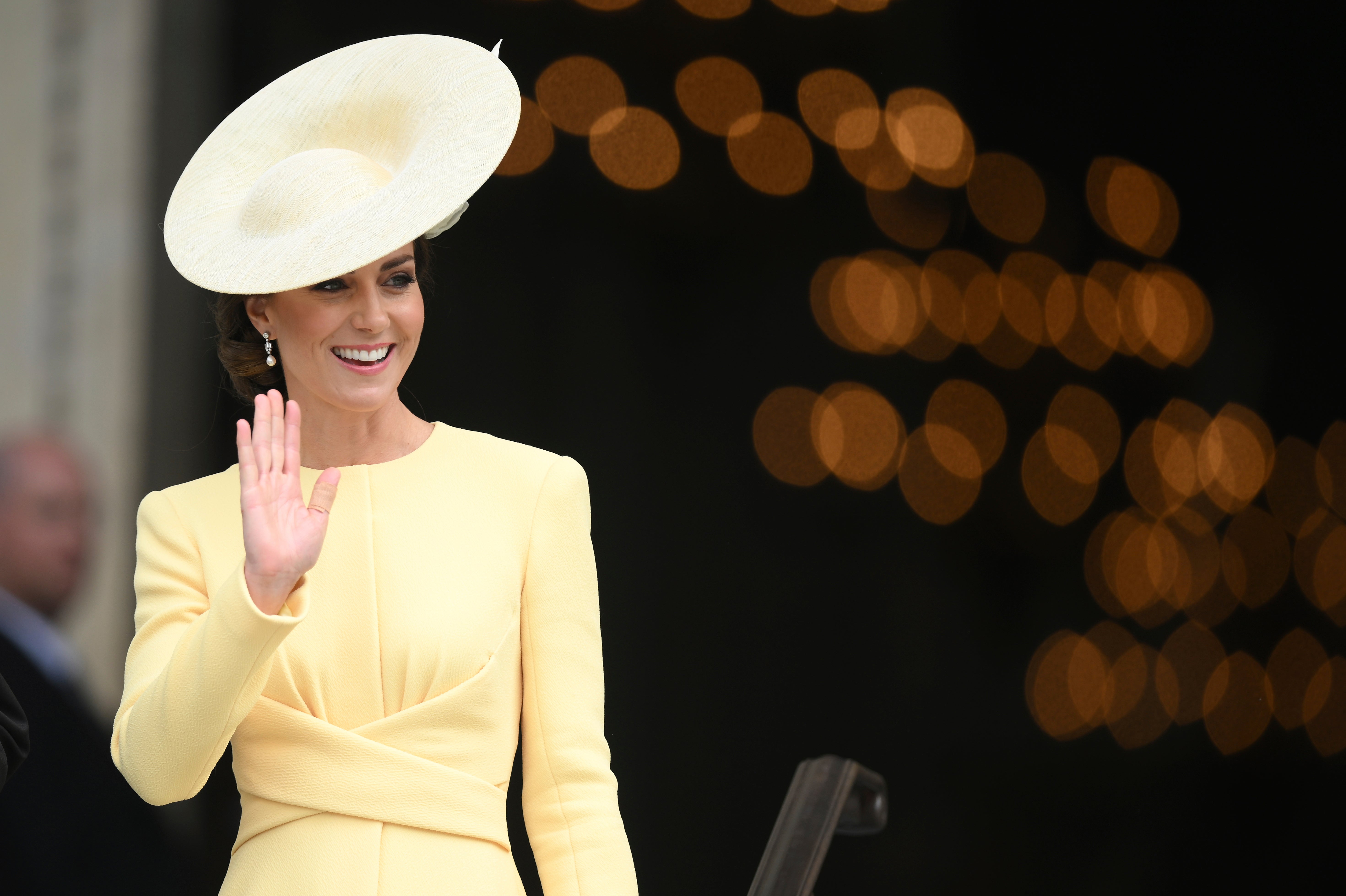 Kate Middleton waves as she leaves the service