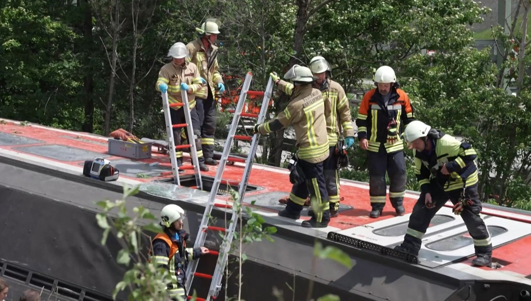 Rescuers standing on an overturned carriage in Burgrain, near Garmisch-Partekirchen, southern Germany