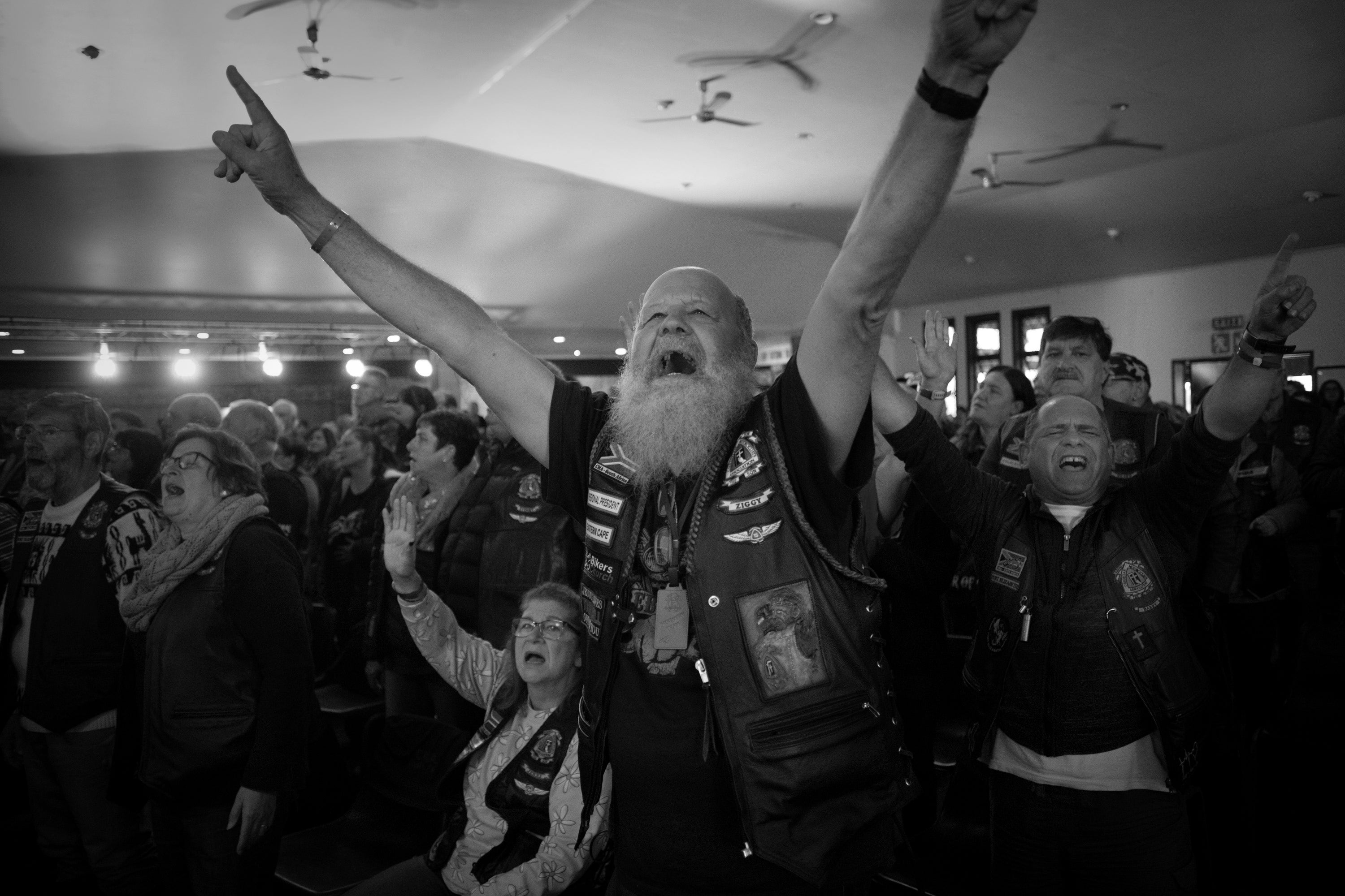 A member jumps up to raise their hands during a performance of the church band at the annual CMA South Africa national rally