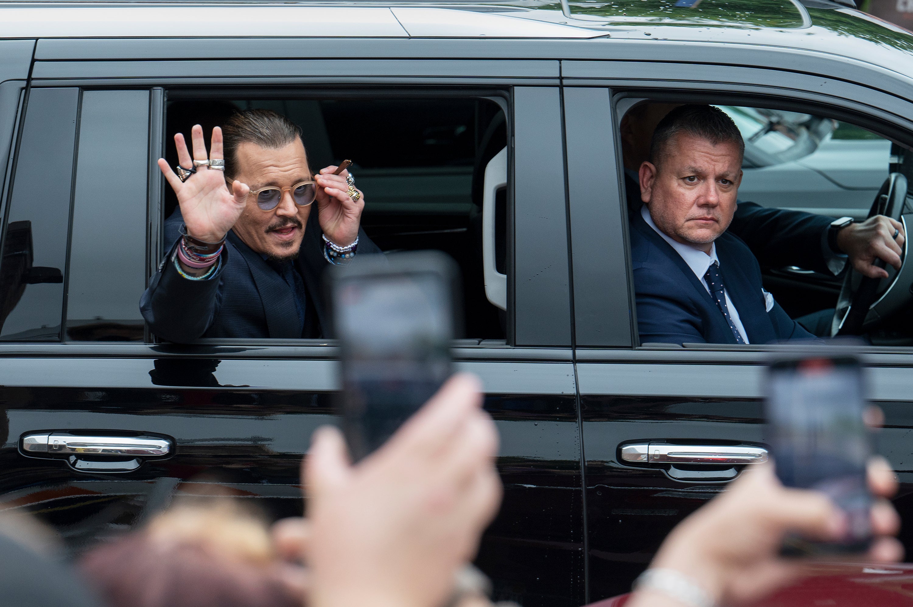 Johnny Depp waving to fans gathered outside the courthouse in Virginia on 27 May