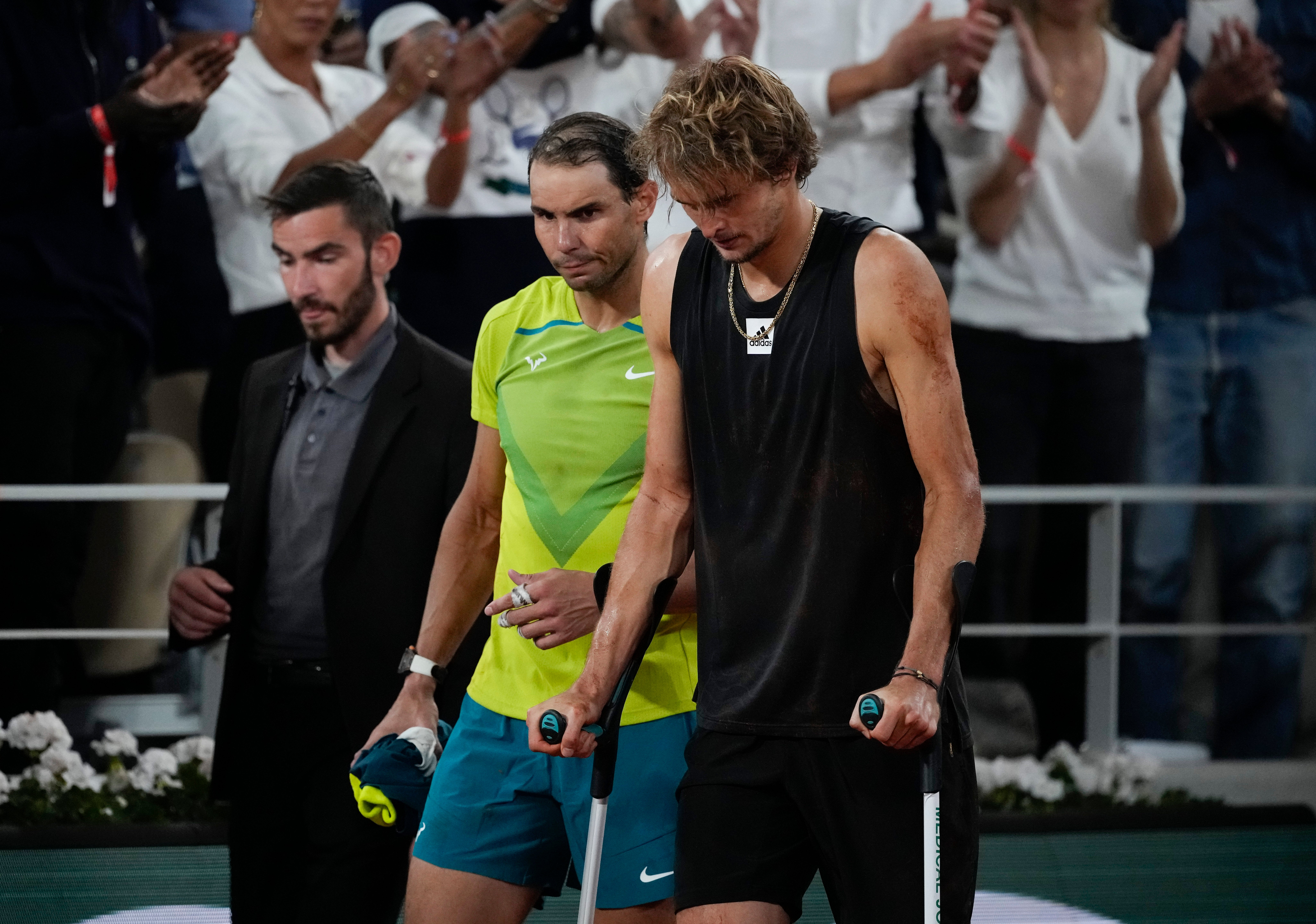 Zverev bravely came back on to court on crutches alongside Rafael Nadal to confirm he could not carry on (Christophe Ena/AP)