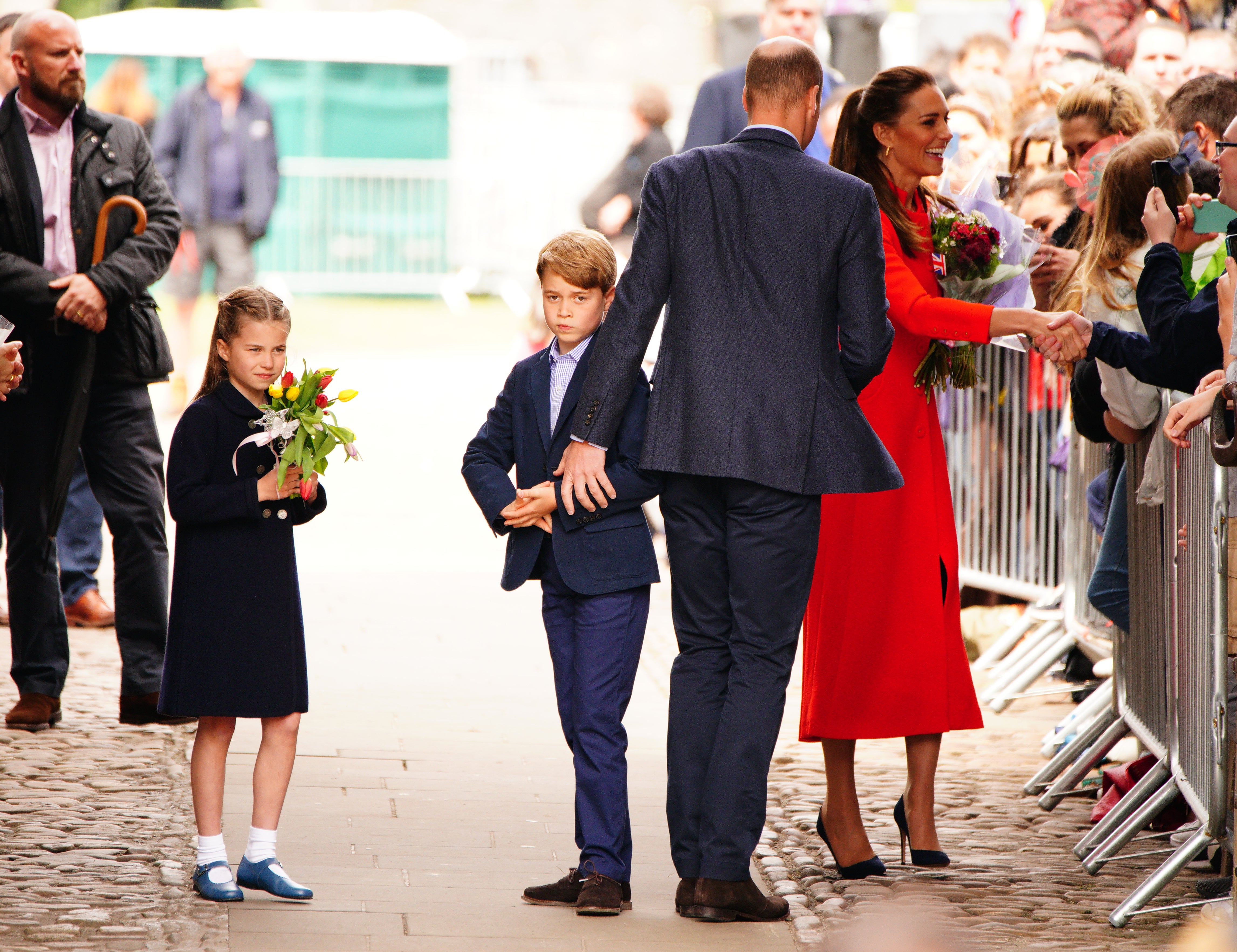 The Duke and Duchess of Cambridge, Prince George and Princess Charlotte speak to wellwishers during their visit to Cardiff Castle (Ben Birchall/PA)