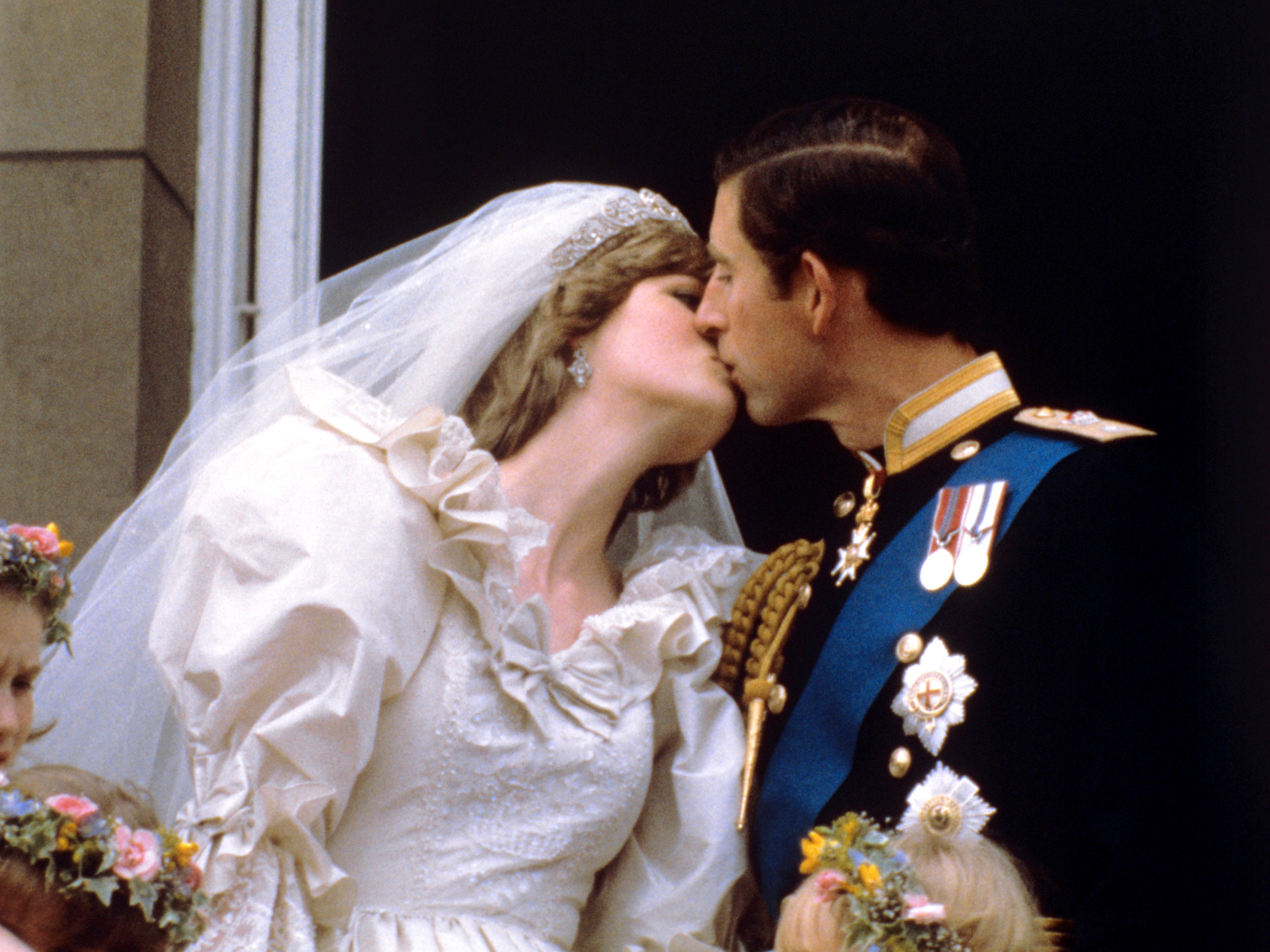 The newly married Prince and Princess of Wales kiss on the balcony after their wedding at St Paul’s