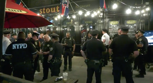 New York police stand outside Féile, on 3 June, 2022, where a man was stabbed in an apparently unprovoked knife attack.