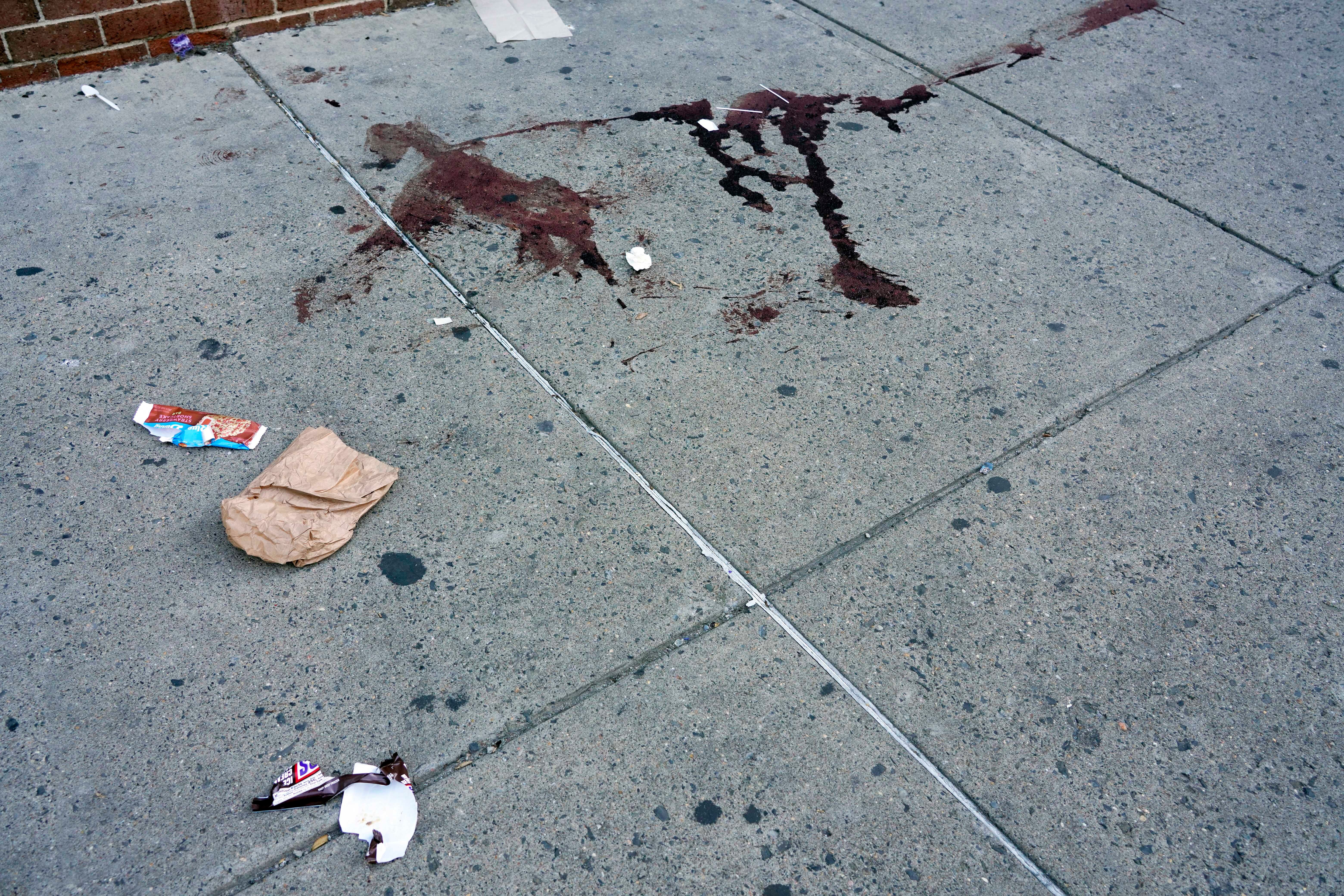 Blood is seen at the scene of a fatal overnight shooting on South Street in Philadelphia, Sunday, June 5, 2022.