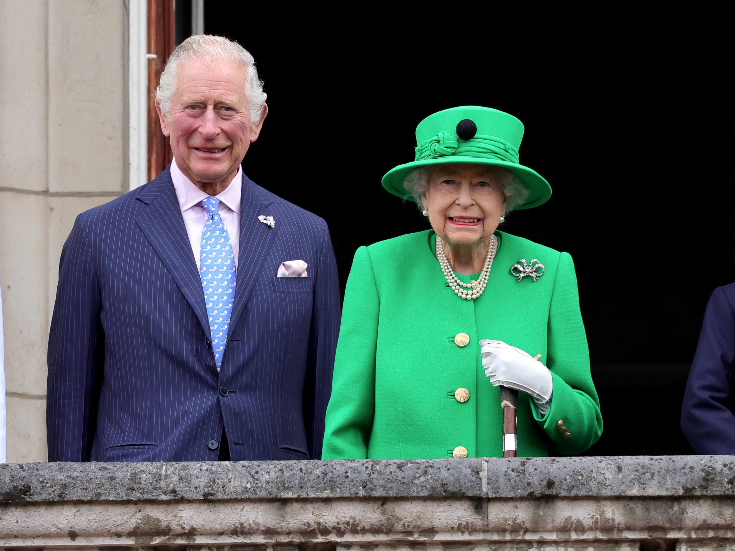 The Queen held a walking stick as she looked out from the palace