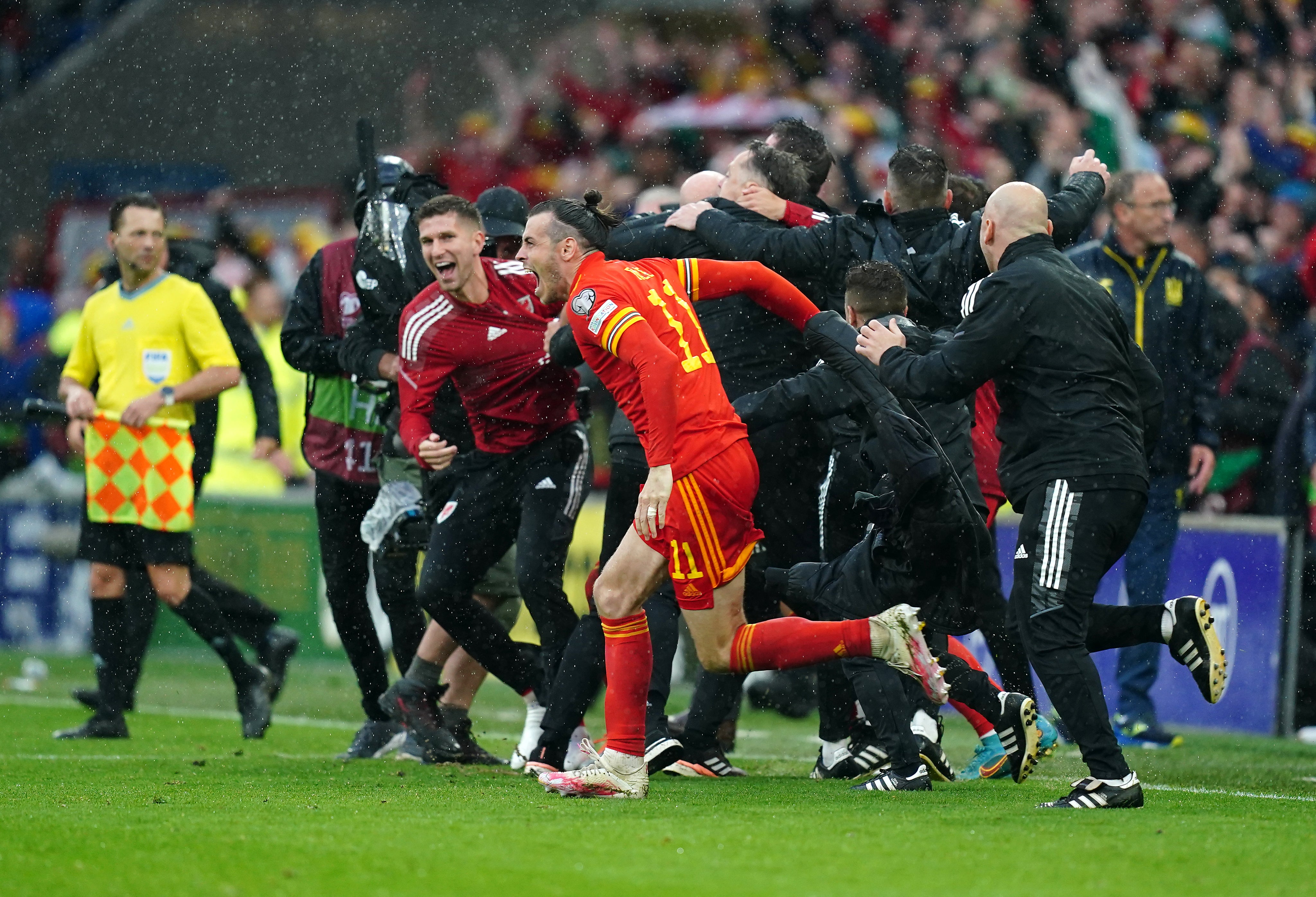 Wales captain Gareth Bale (centre) celebrates with team-mates and staff after qualifying for the 2022 World Cup (David Davies/PA)