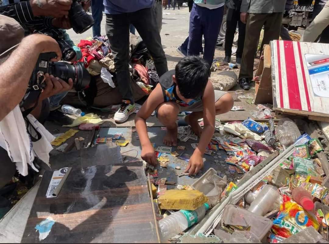 Rahima’s 11-year-old son seen picking up the pieces of what was left of his family’s shop in Jahangirpuri