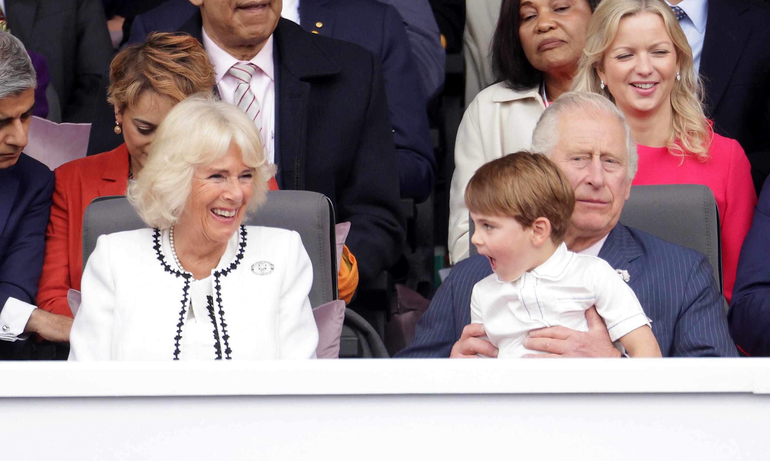 Louis was seen sitting on Prince Charles’ lap