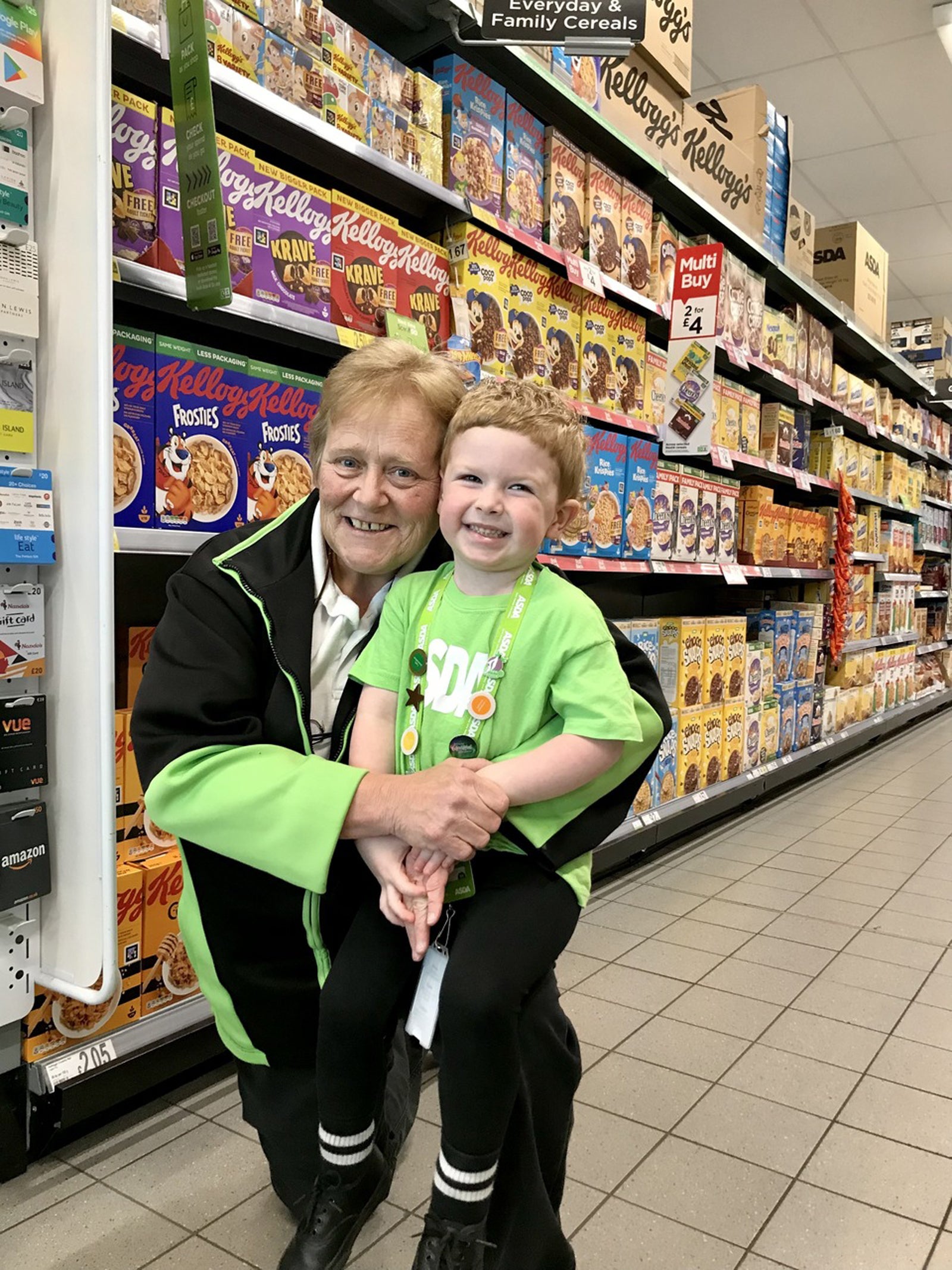 Three-year-old Hudson Wickens with store worker Mags Lunn, who has forged a remarkable friendship with the little boy (Asda/PA)