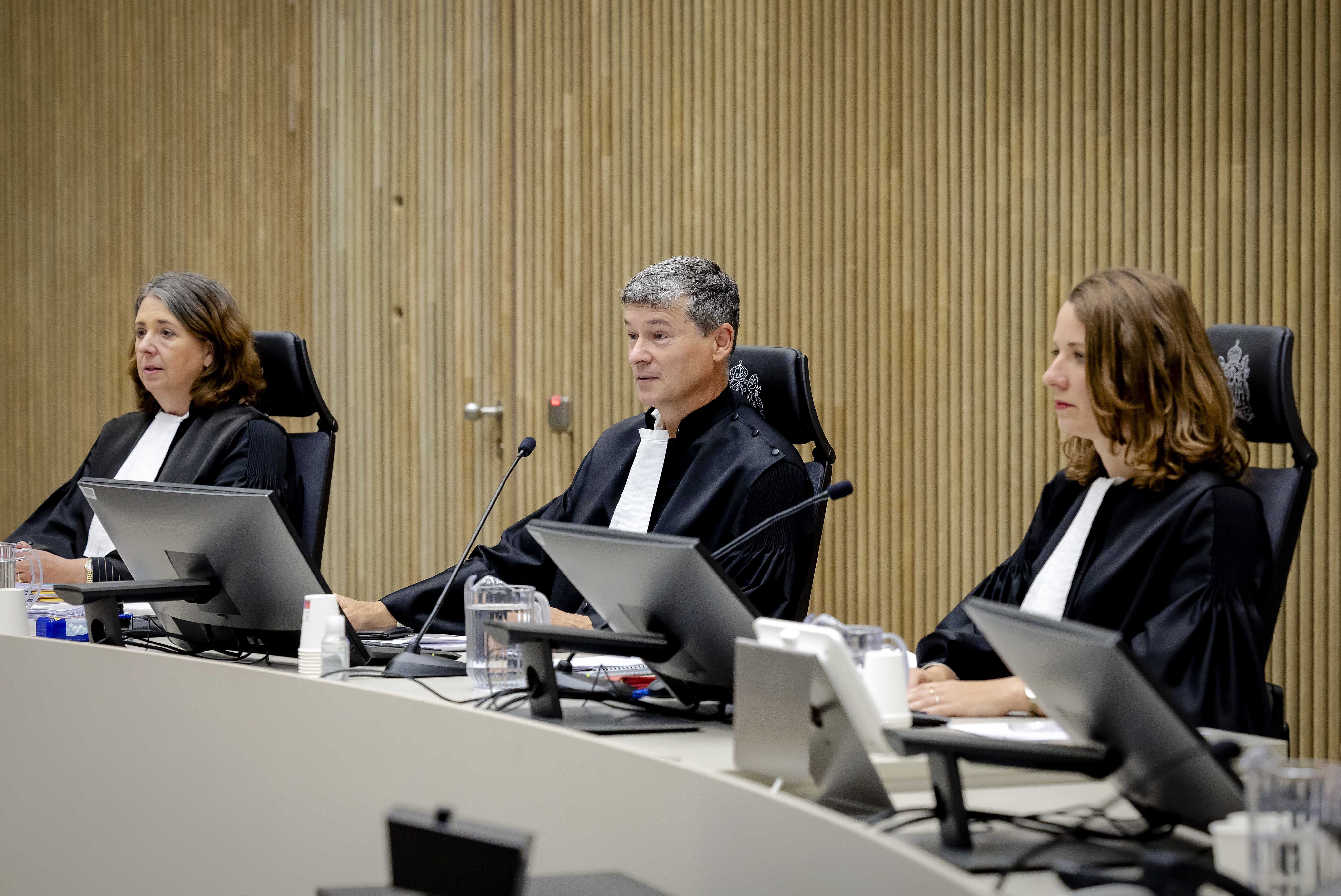 Three judges are pictured before the start of criminal proceedings against the suspects