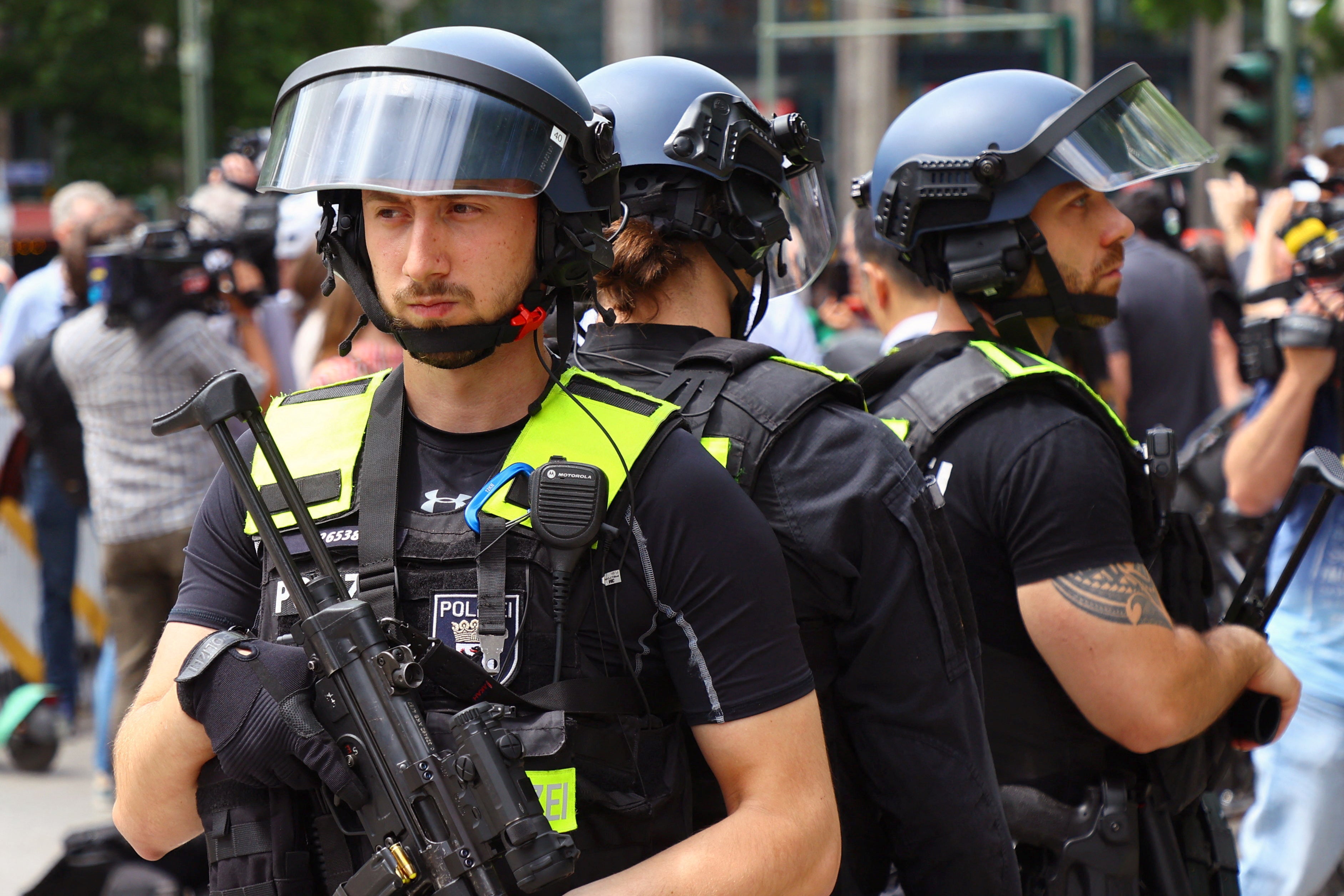 A police tactical team secures the area, near a car that crashed into a group of people before hitting a storefront at Tauentzienstrasse