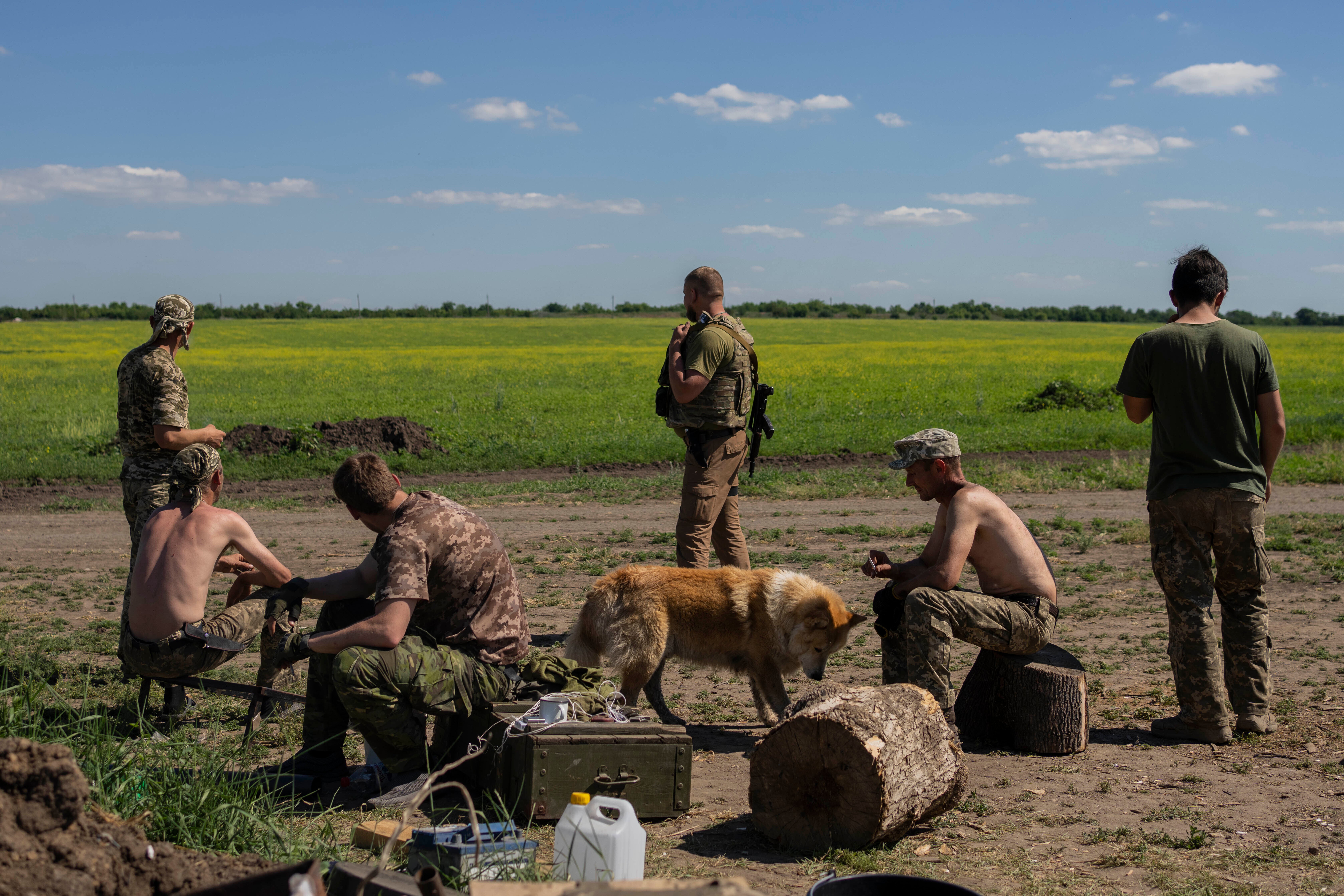 Ukrainian servicemen rest after digging trenches near the frontline in Donetsk, eastern Ukraine on Wednesday