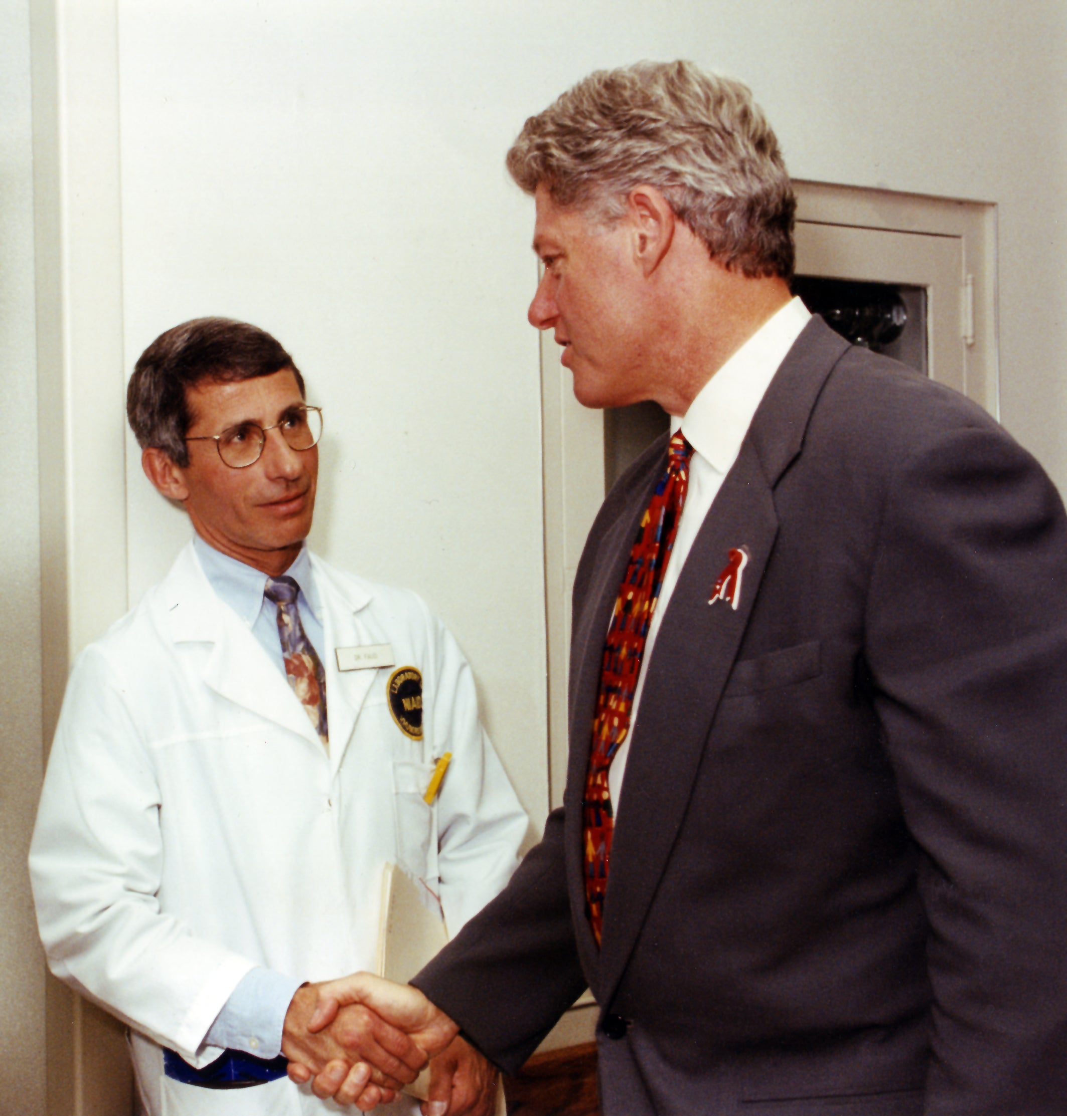 Dr Fauci shaking hands with President Bill Clinton in 1997