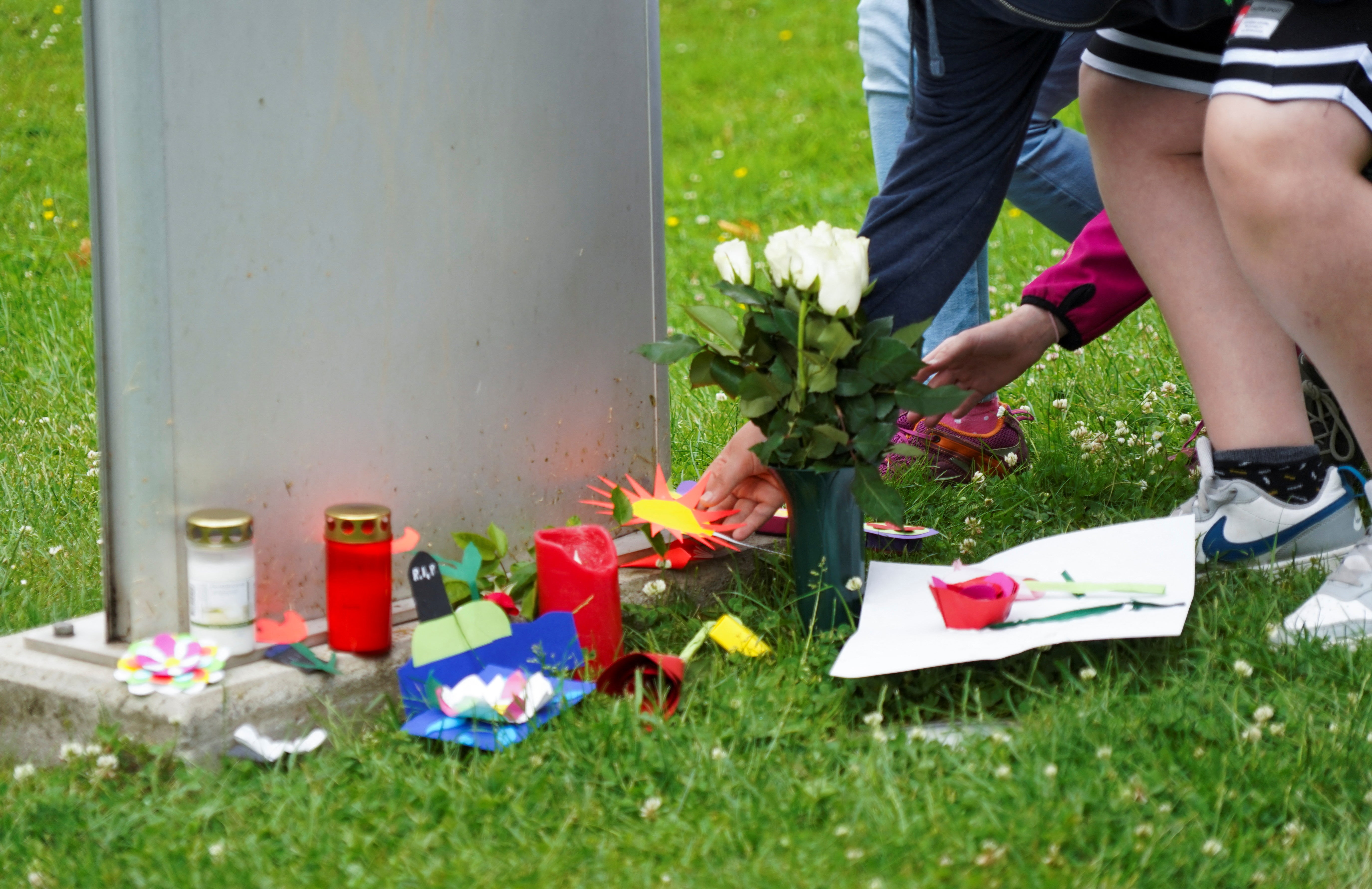 A pupil of the Kaulbach secondary school places a sticker in front of the school in Bad Arolsen