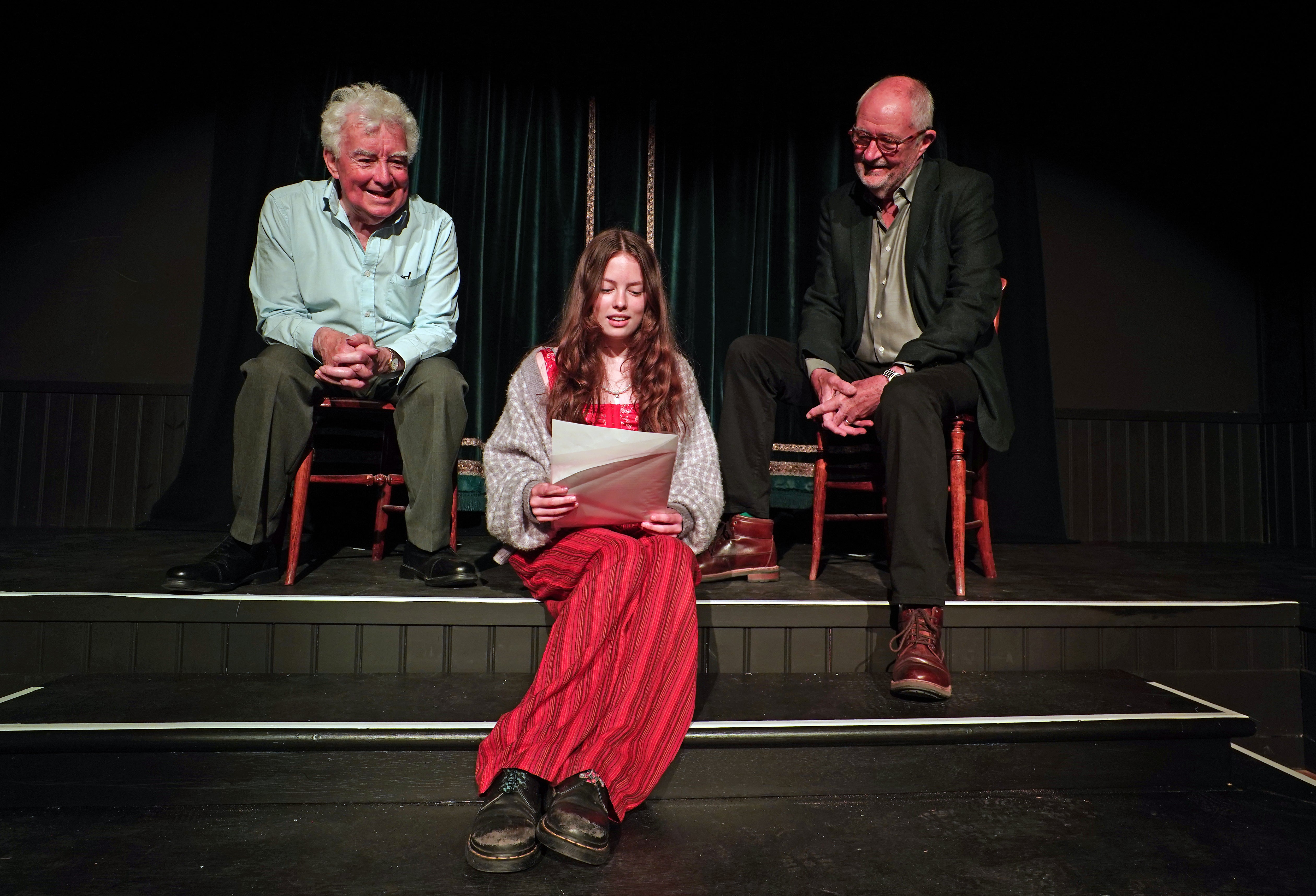 John Bright, costume designer and founder of The Bright Foundation (left) and actor Jim Broadbent (right) help Piper Wren with a rehearsal of a poem created for the launch of the Bright Foundation Barn Theatre and Museum at Rodgers Farm in Westfield, Hastings (Gareth Fuller/PA)