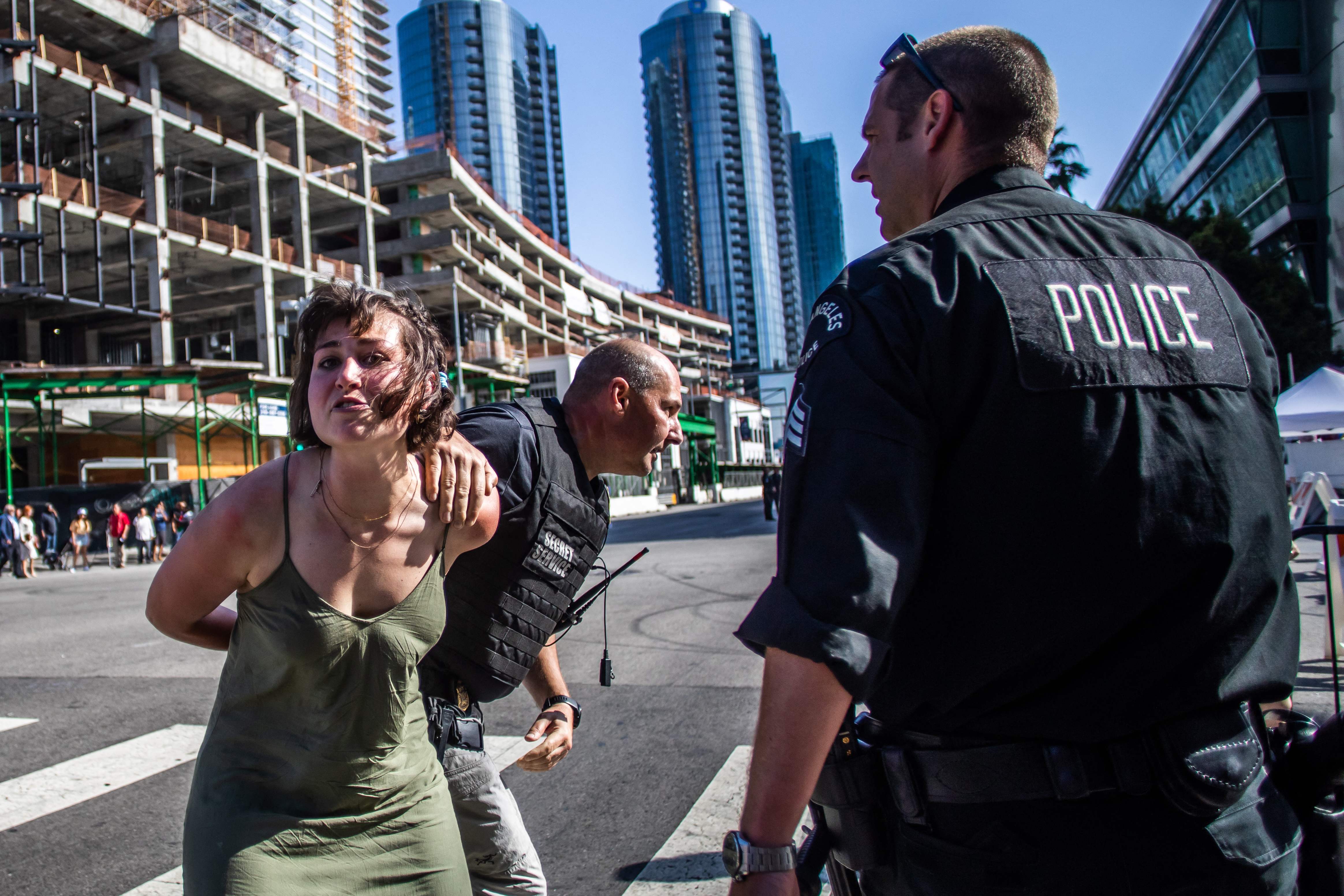 A Secret Service police officer arrests a protester after she ran towards a motorcade on its way to the LA Convention Center where North and South American leaders are gathered for the ninth Summit of the Americas in Los Angeles, June 8, 2022