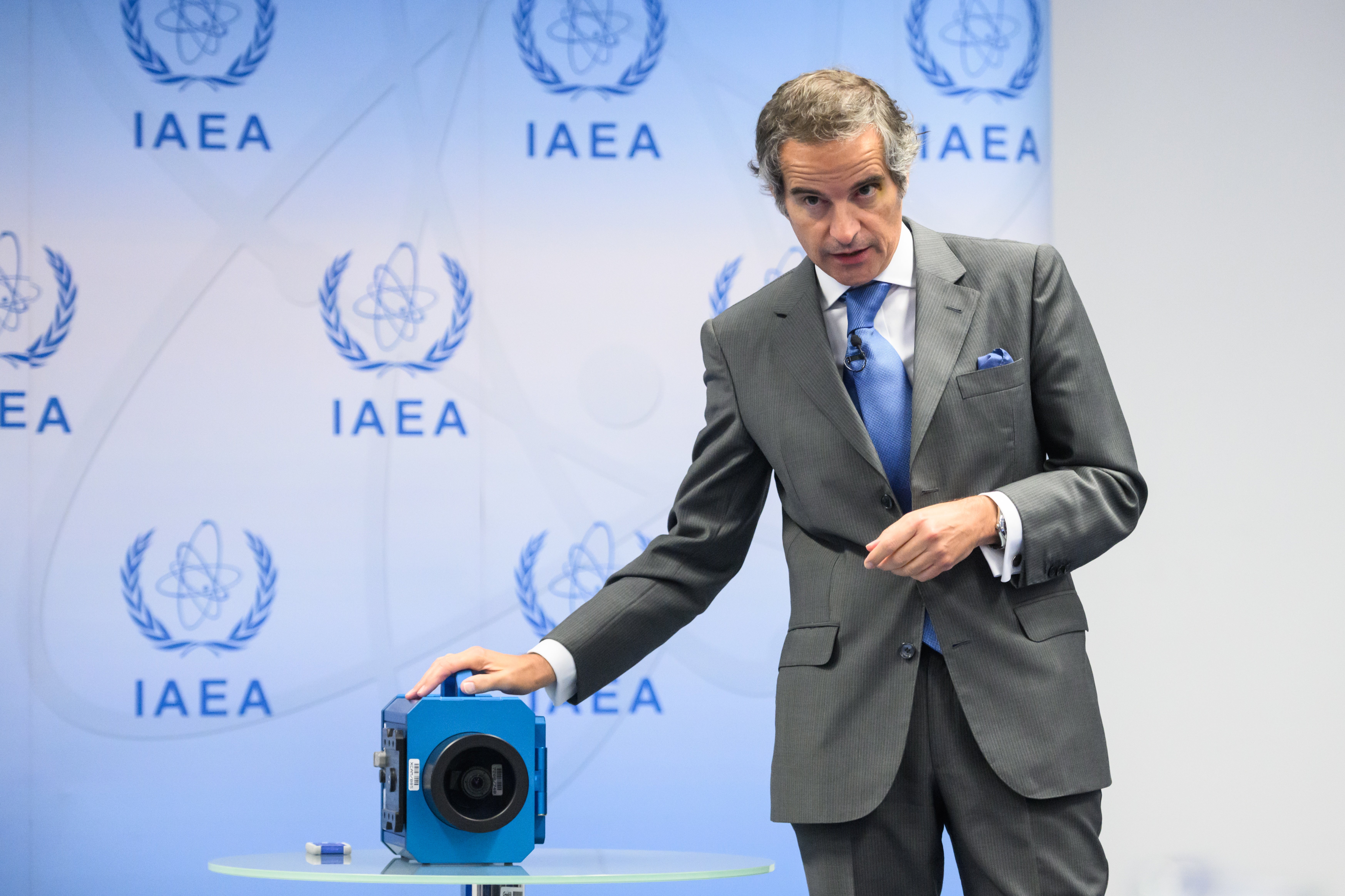 Director General of the International Atomic Energy Agency (IAEA) Rafael Mariano Grossi speaks next to a surveillance camera during a press conference in Vienna