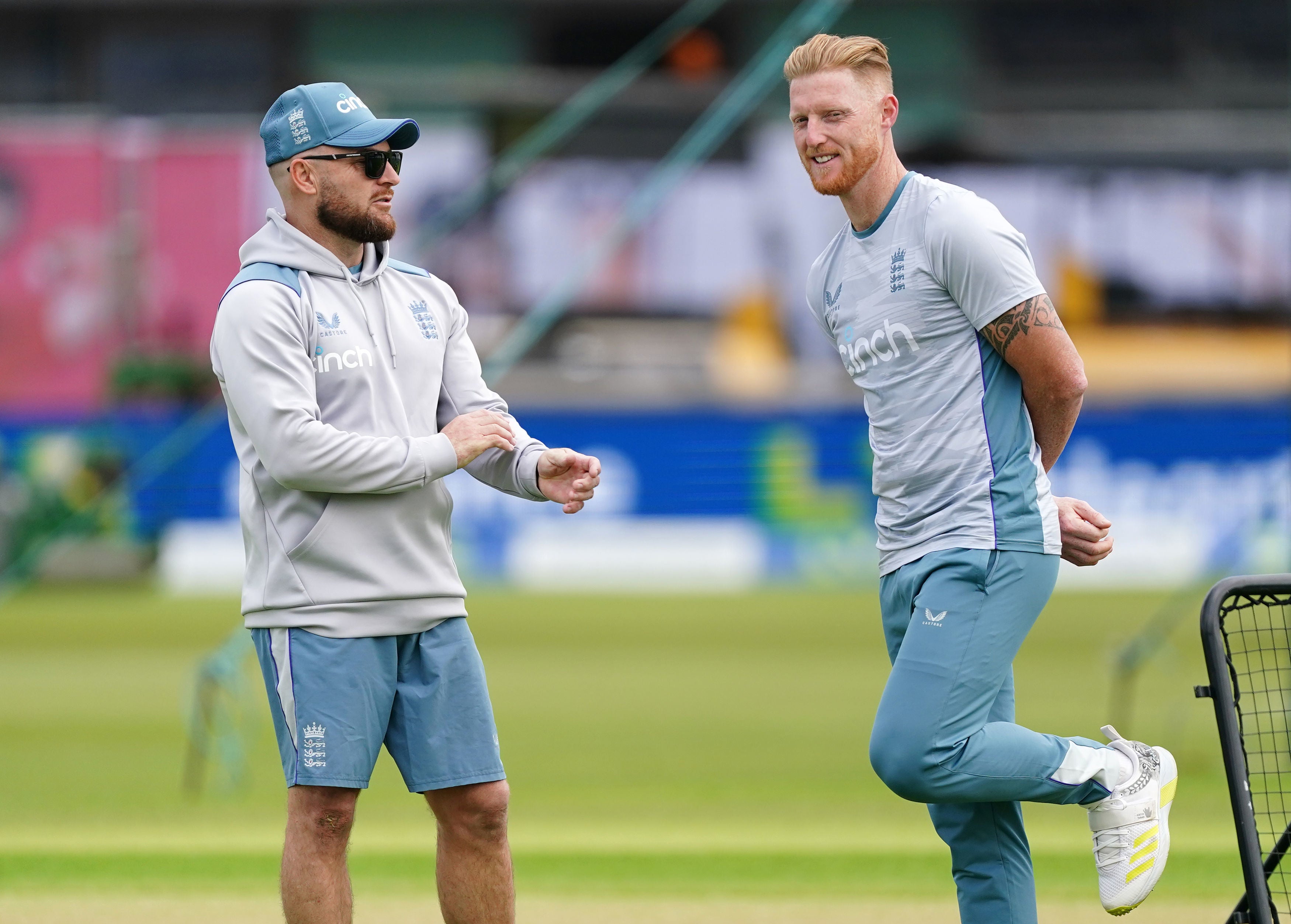 Coach McCullum (left) and Ben Stokes chat during a nets session