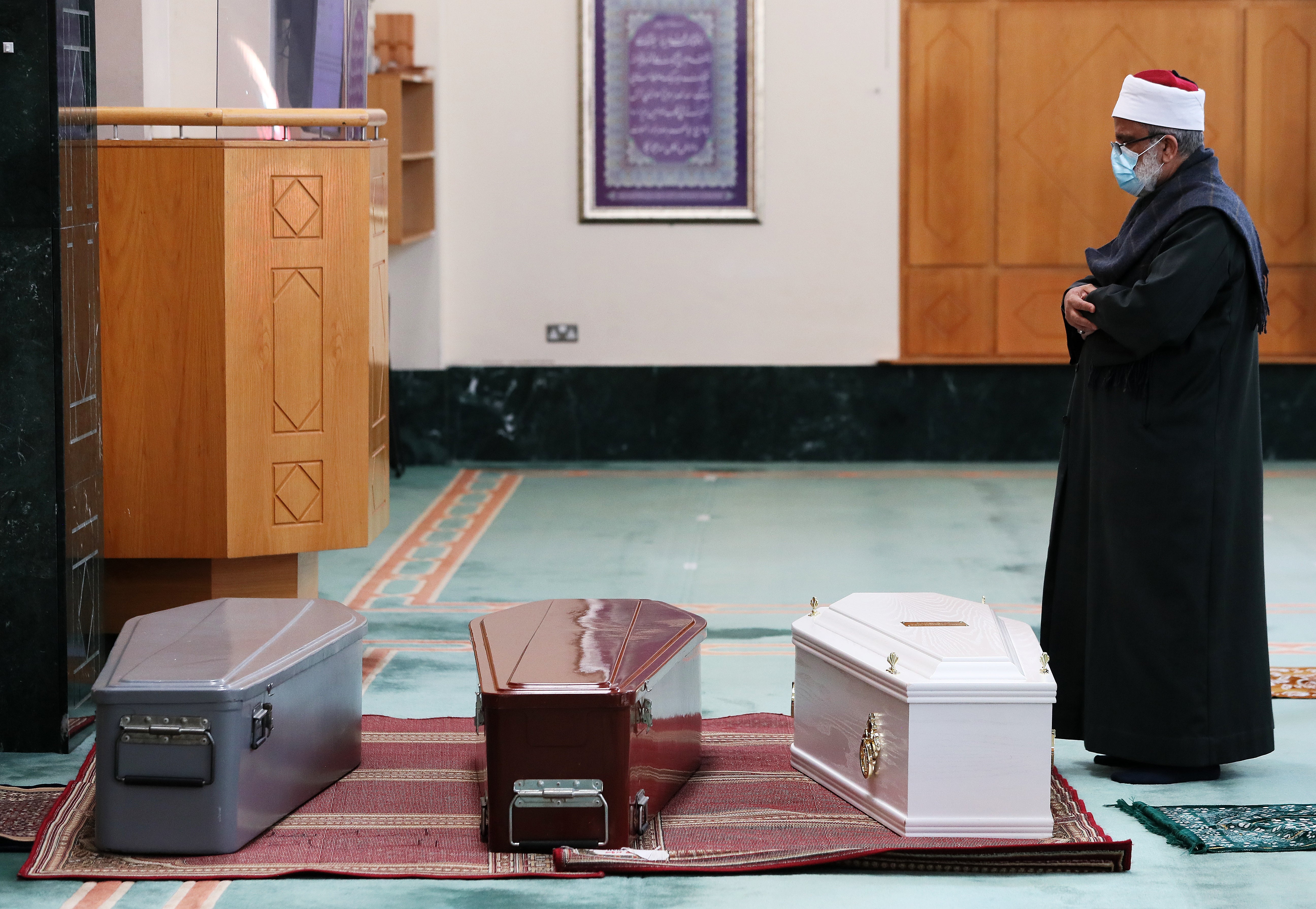 An imam prays over the coffins of 37-year-old Seema Banu, and her 11-year-old daughter Asfira Syed and six-year-old son Faizan Syed at the Islamic Cultural Centre in Dublin ahead of their burial in Newcastle cemetery in 2020 (Brian Lawless/PA)