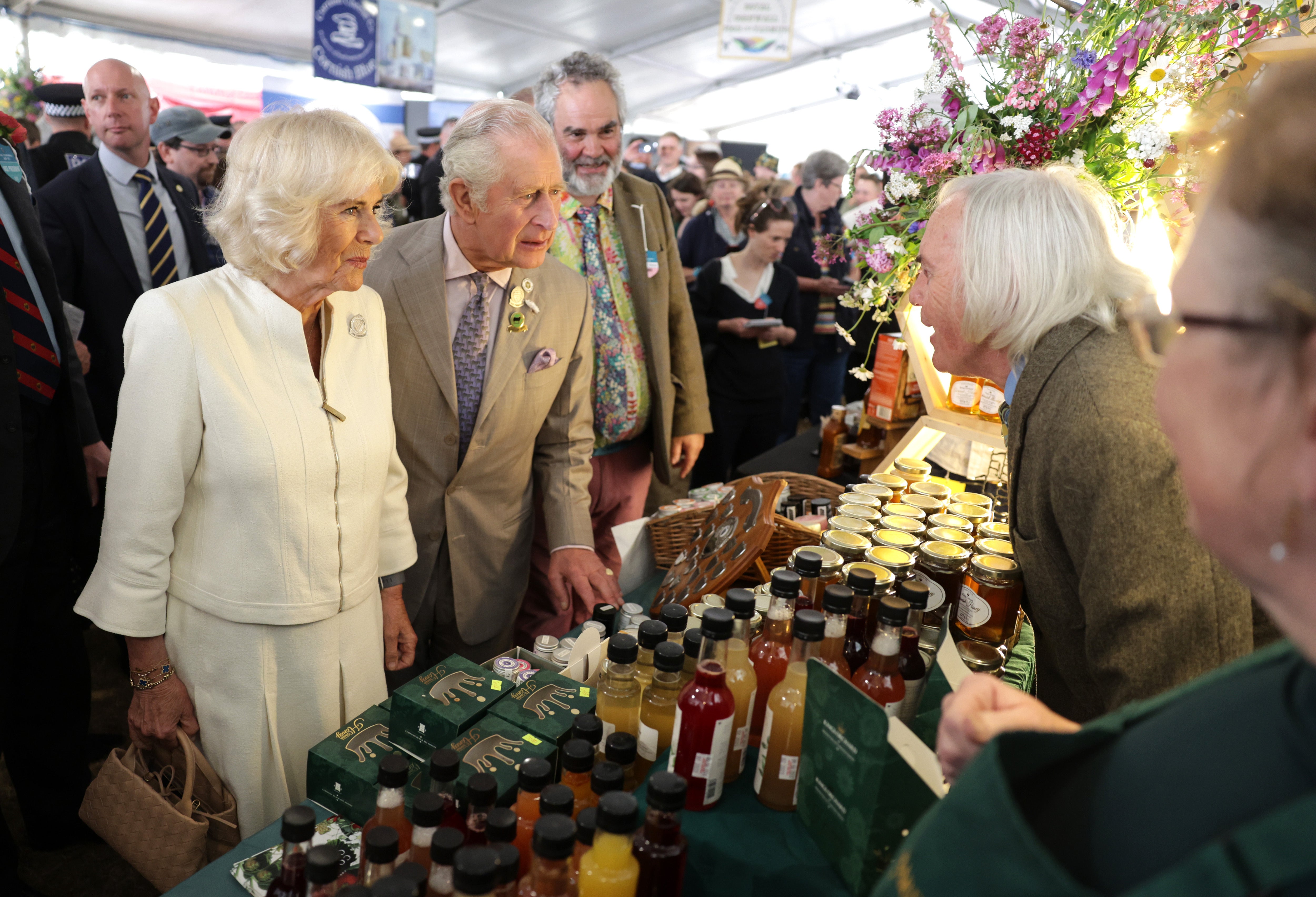 The Duchess of Cornwall and the Prince of Wales speak to exhibitors at the Royal Cornwall Show (PA)