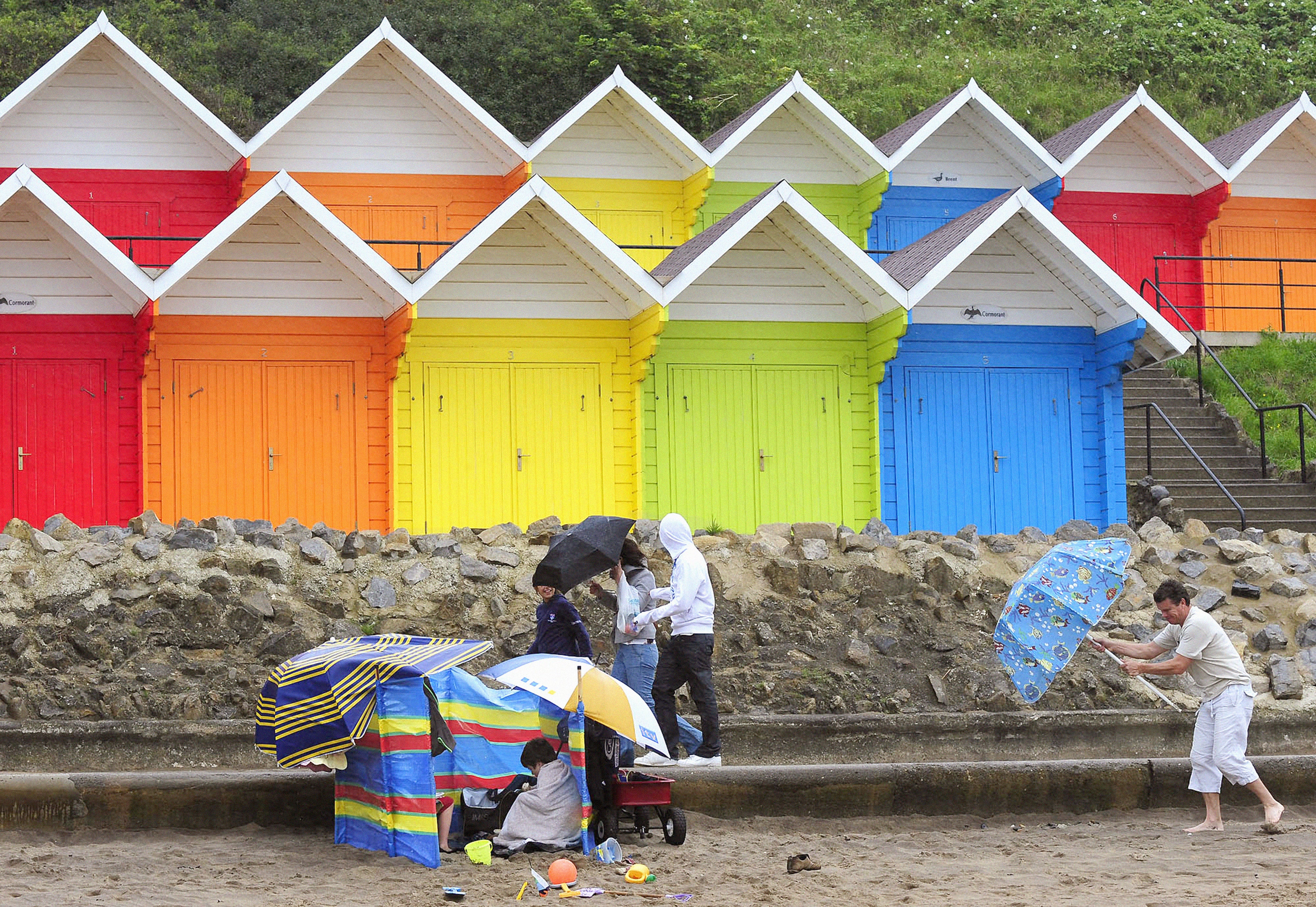 Holidaymakers in strong winds (PA)