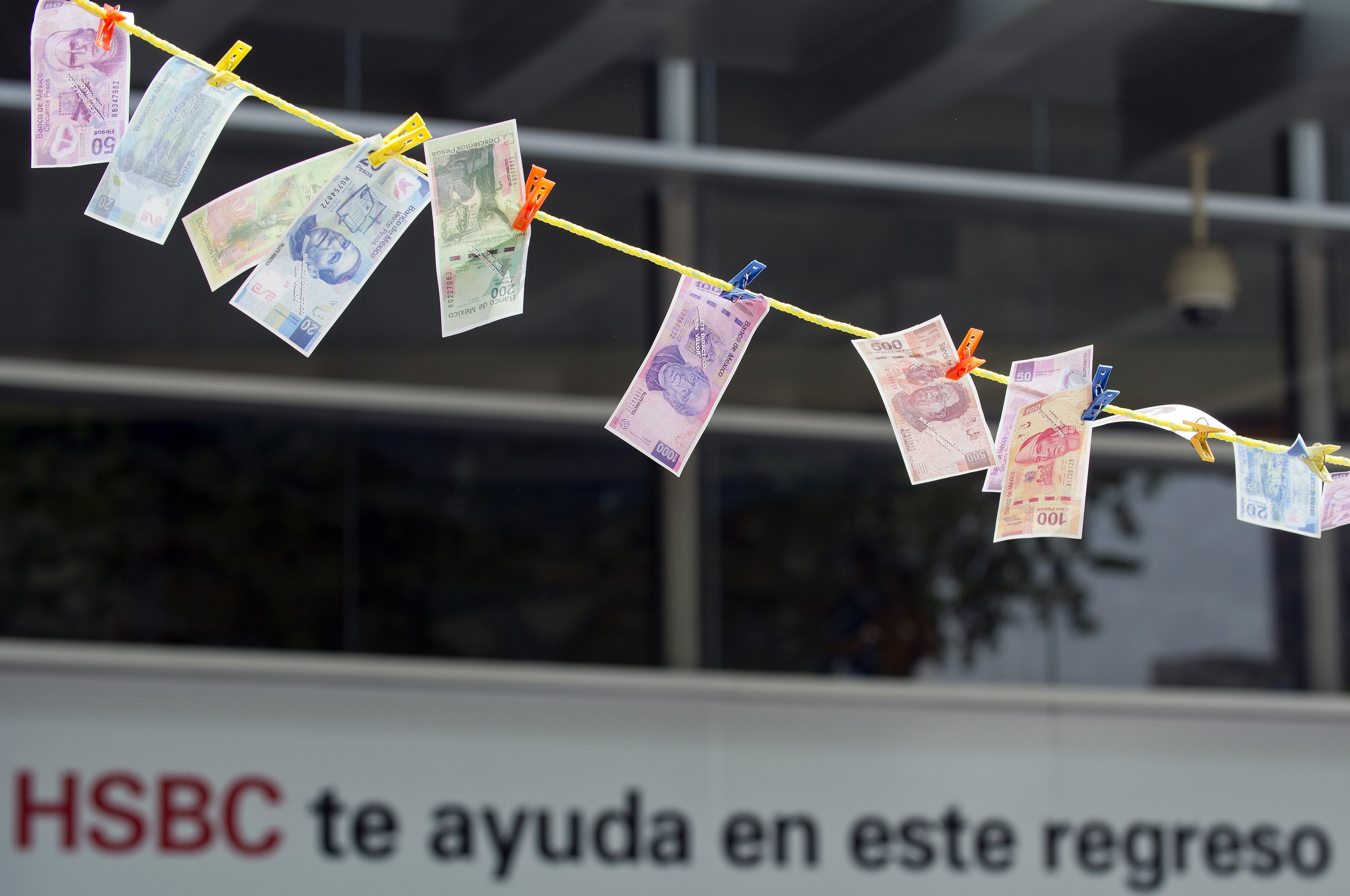 Fake notes were put in the sun ‘to dry’ during a protest in front of a HSBC branch building in Mexico City