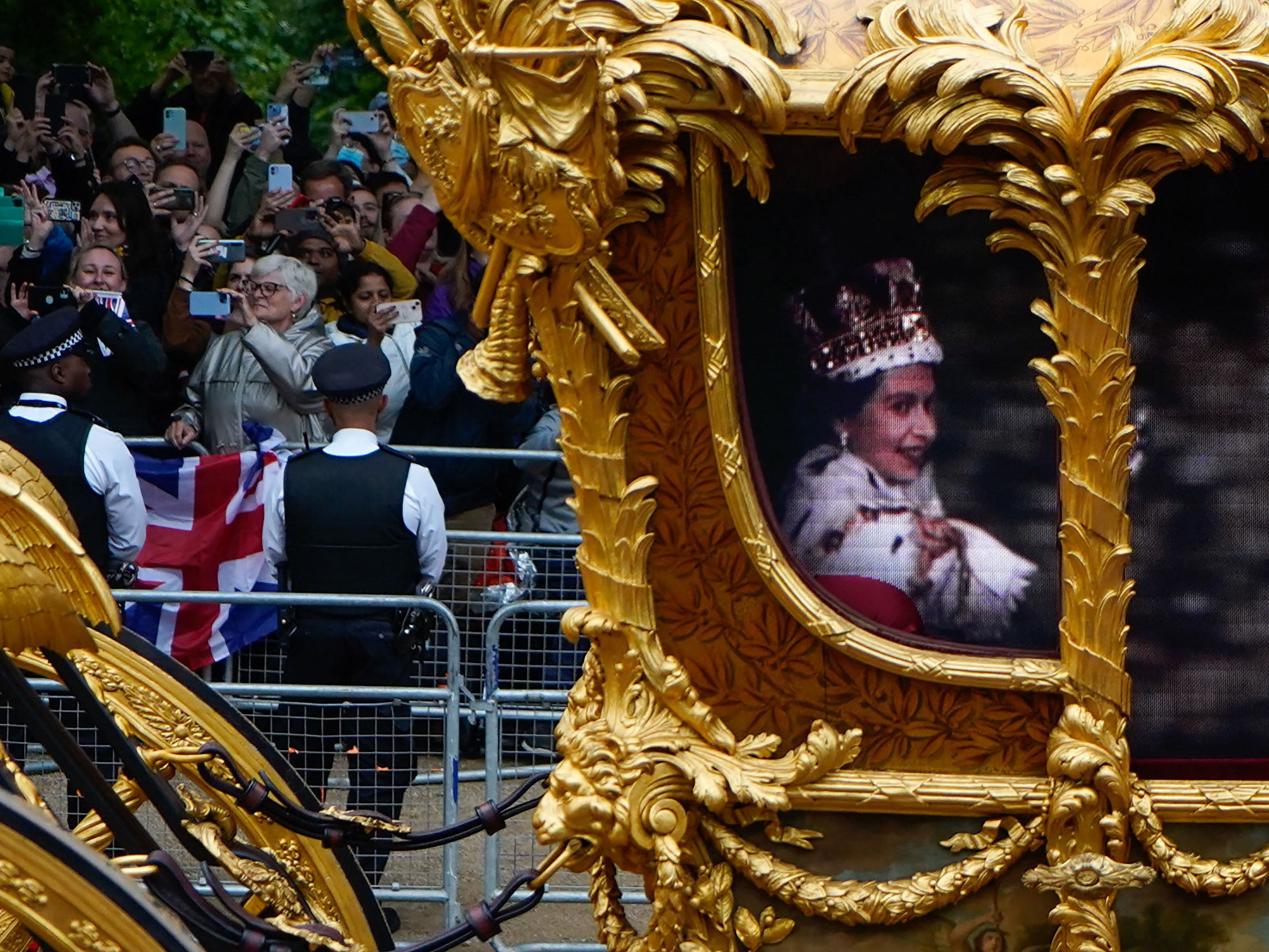 Flanked by guardsmen on horseback to complete the illusion, the CGI Queen was glimpsed enthusiastically gesturing to the crowds