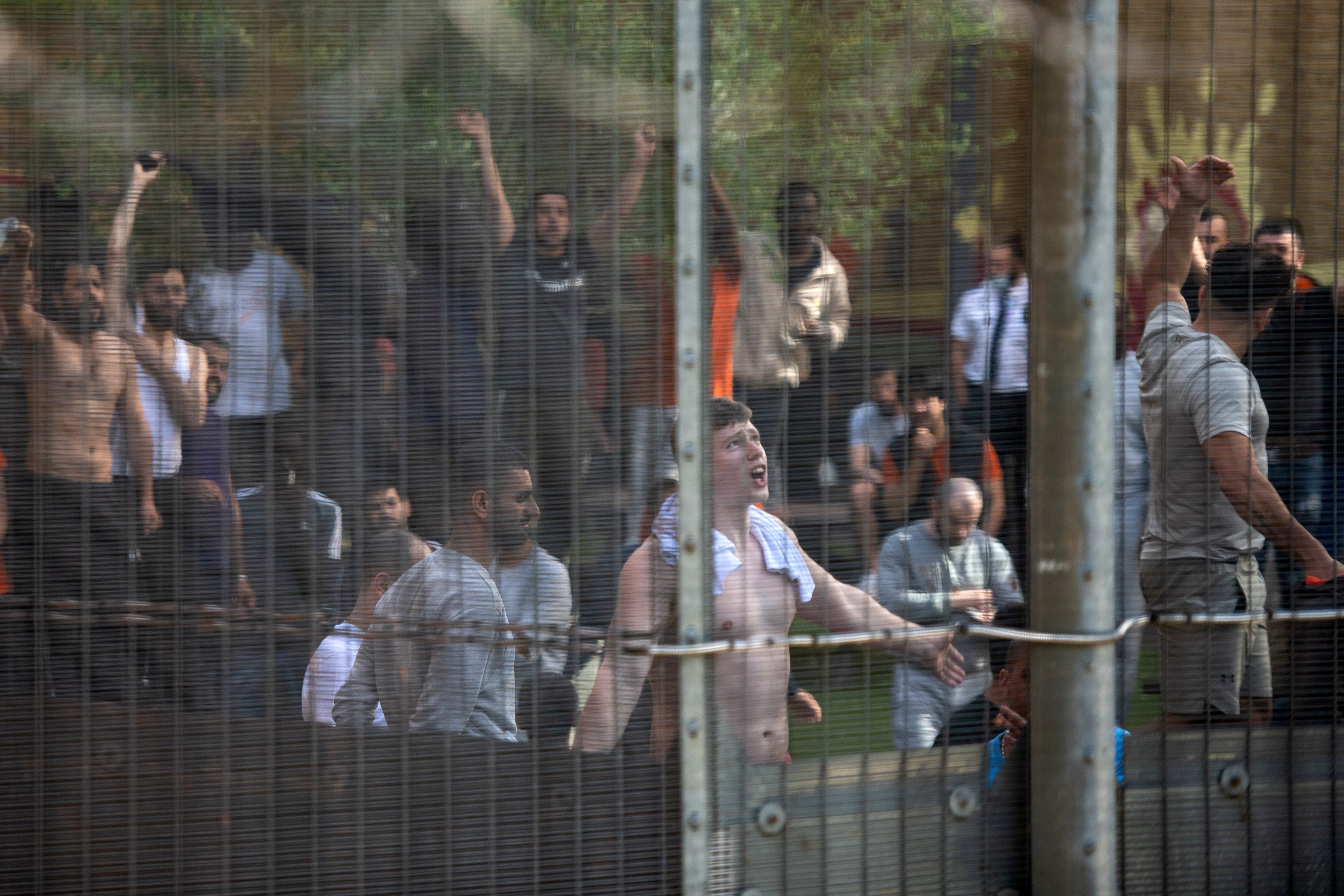 Detainees at Brook House Immigration Removal Centre shout and chant in unison with protesters outside of the centre