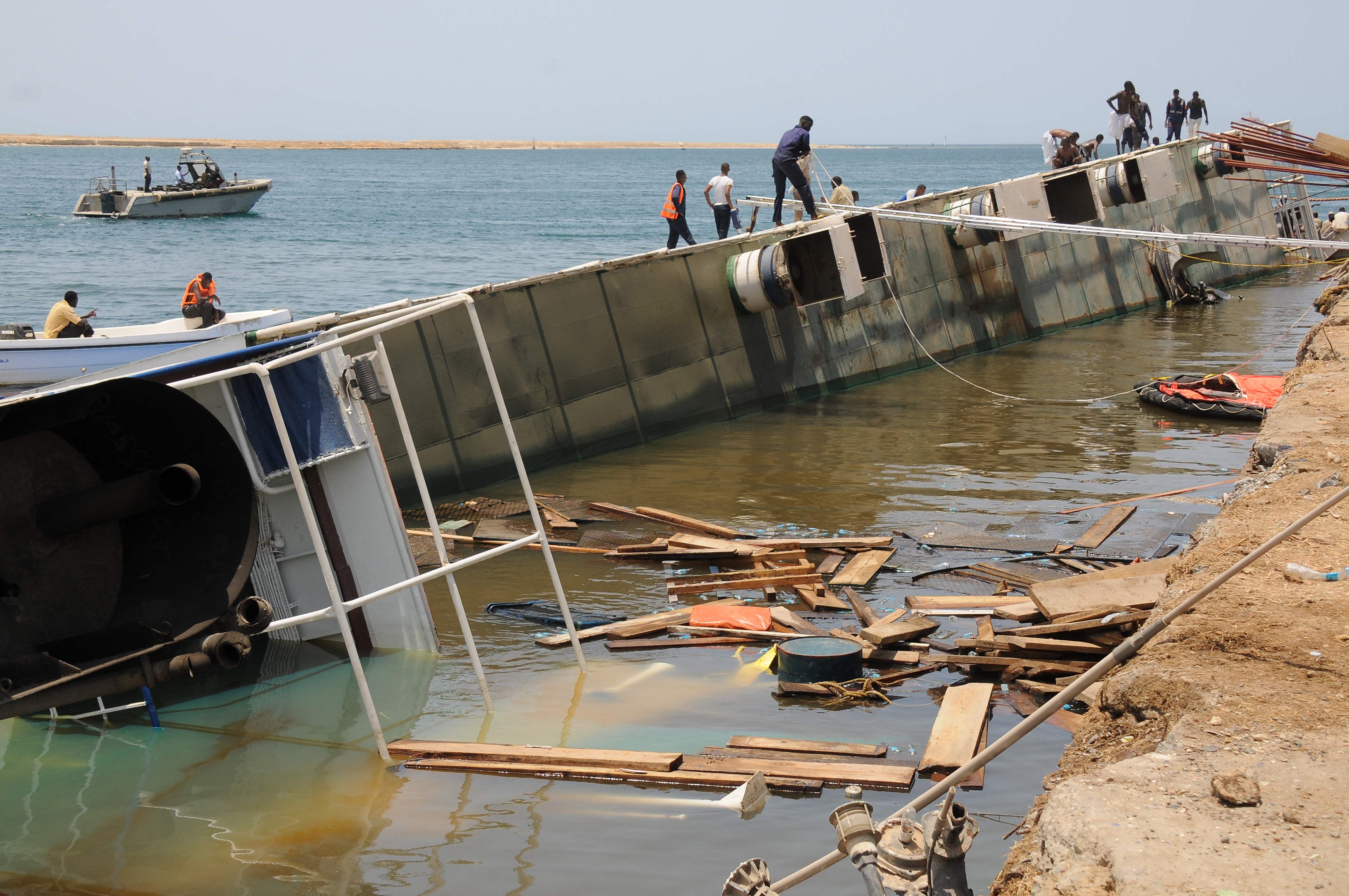 Men search for sheep on board the livestock vessel