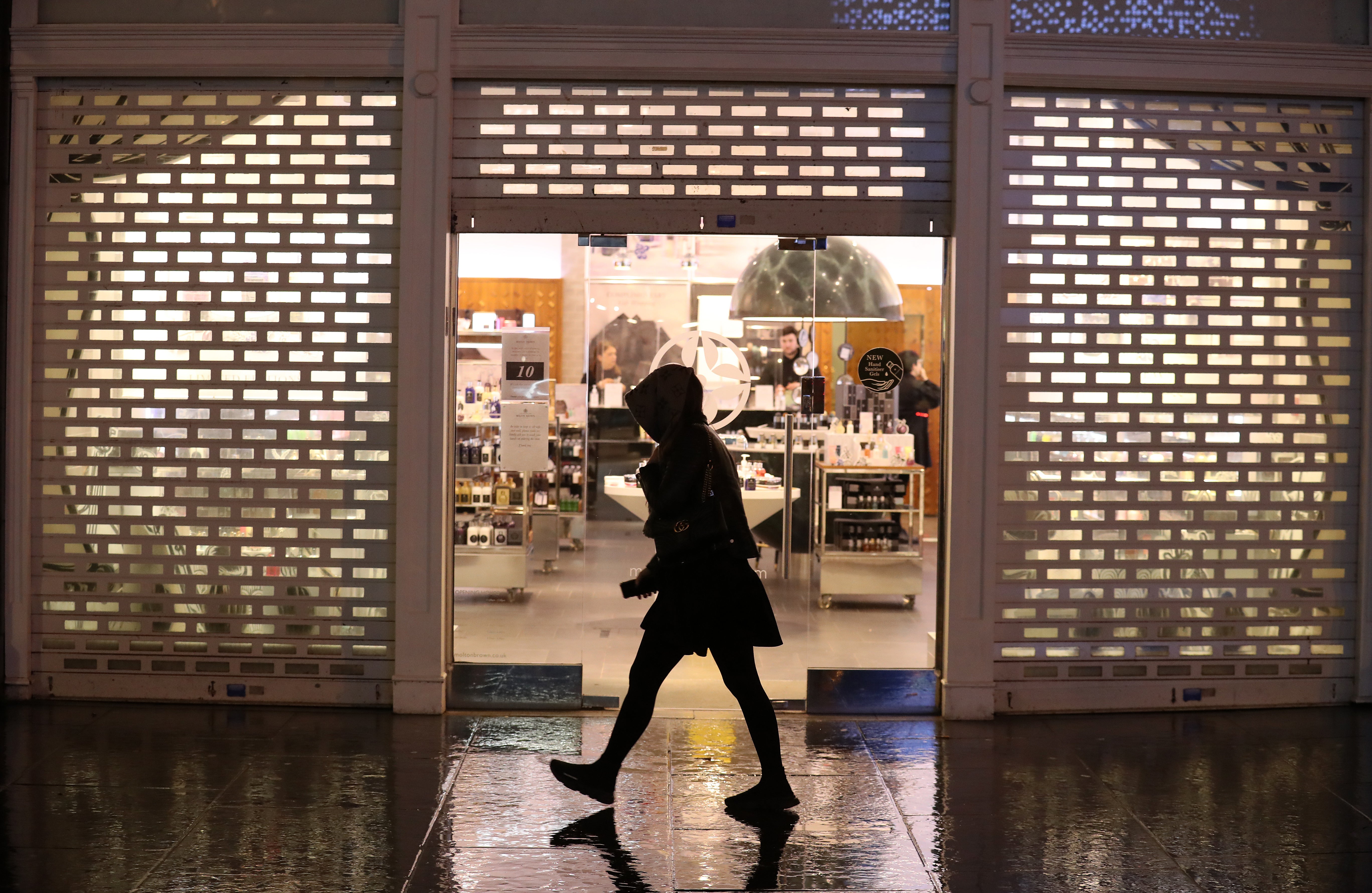 Shutters come down at a shop as it closes (Andrew Milligan/PA)