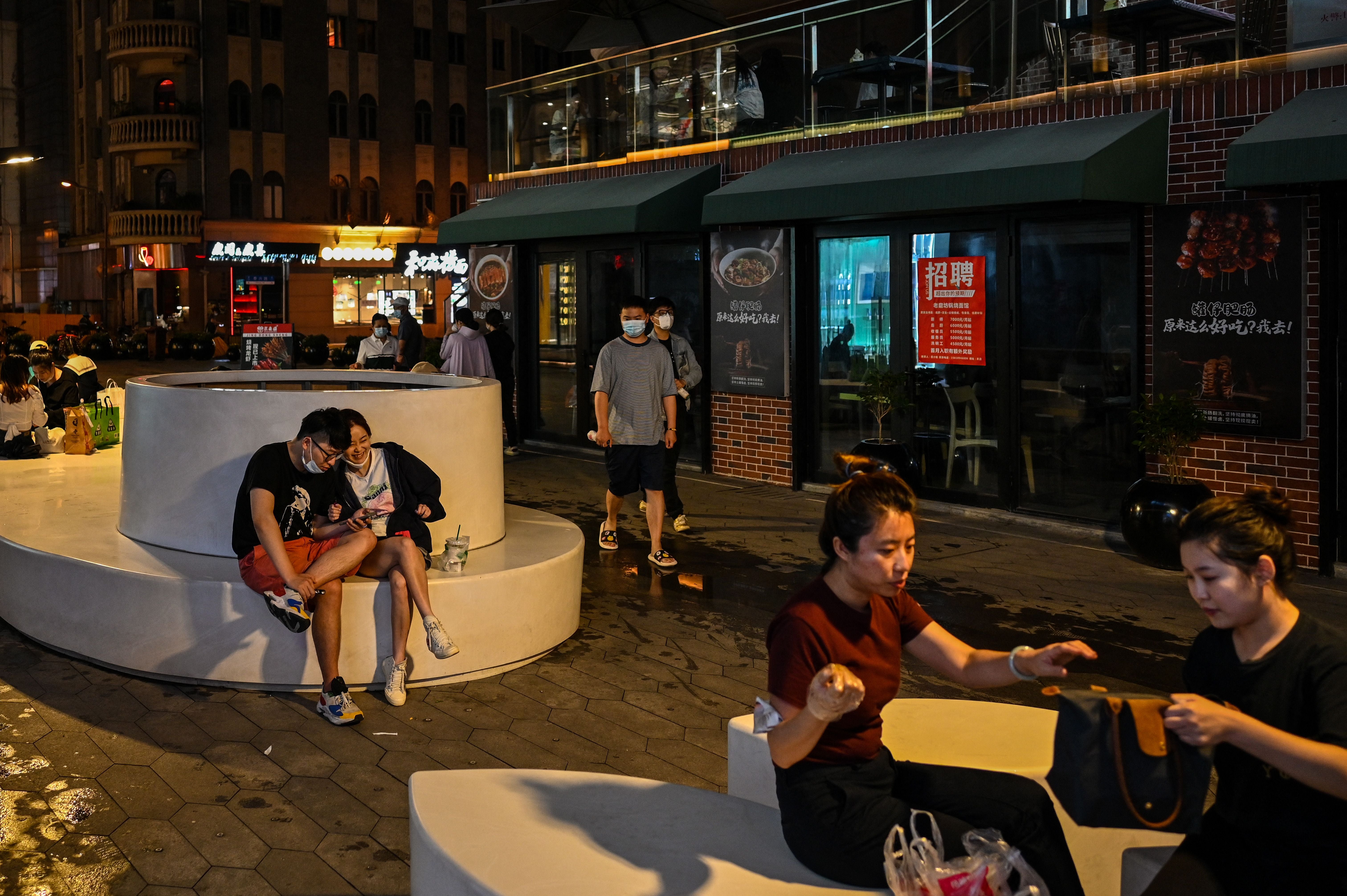 People are seen on a pedestrian street in the Jing’ an district of Shanghai